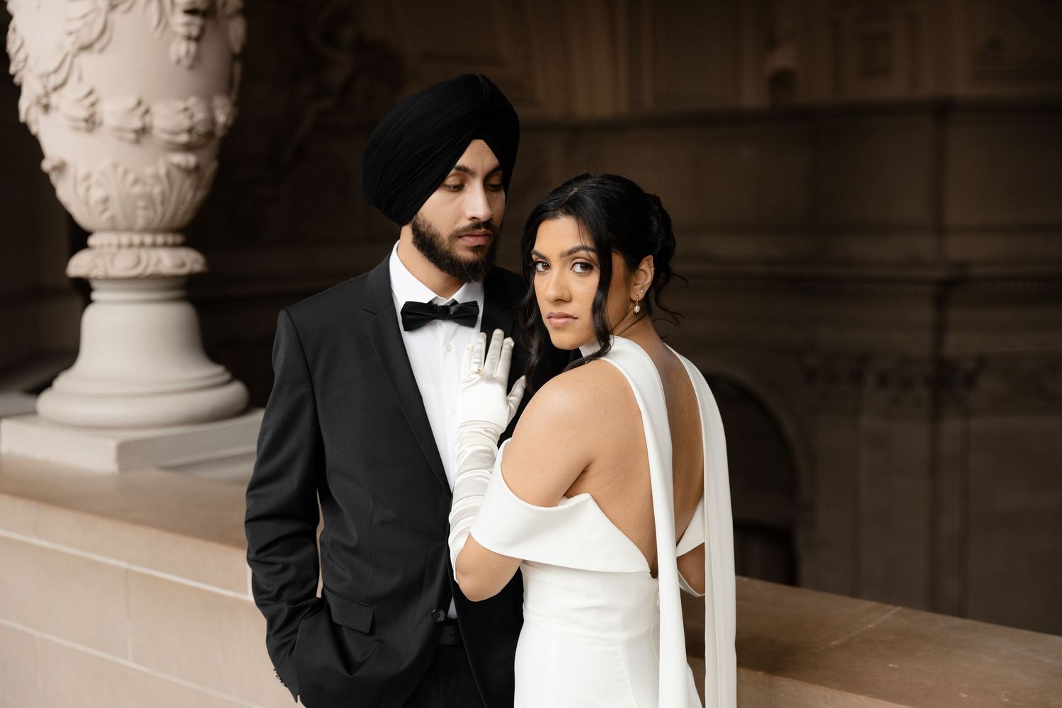 A dramatic wedding photo series captured in a classic architectural setting.