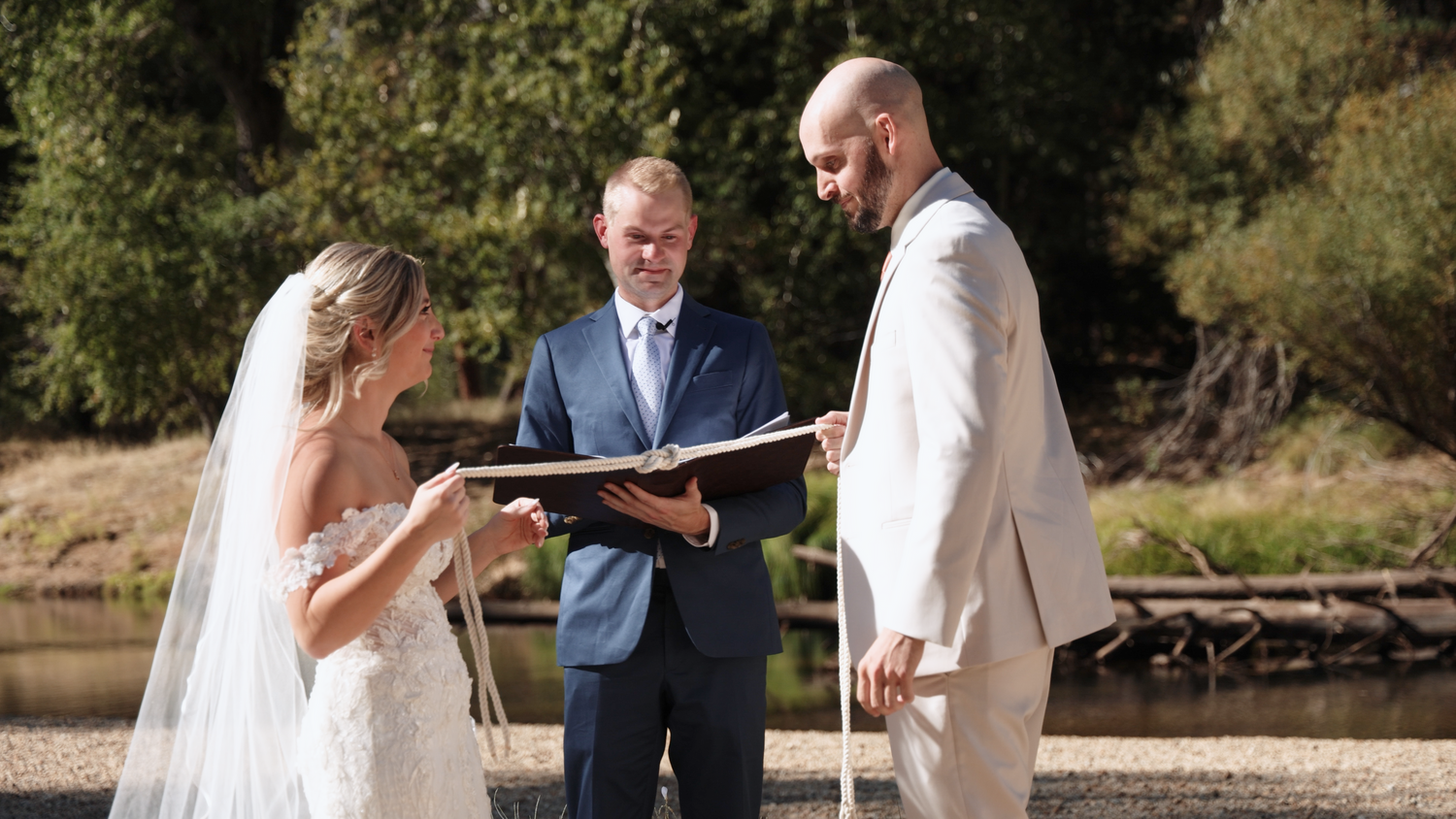 Intimate wedding ceremony taking place in front of towering cliffs at Yosemite National Park.