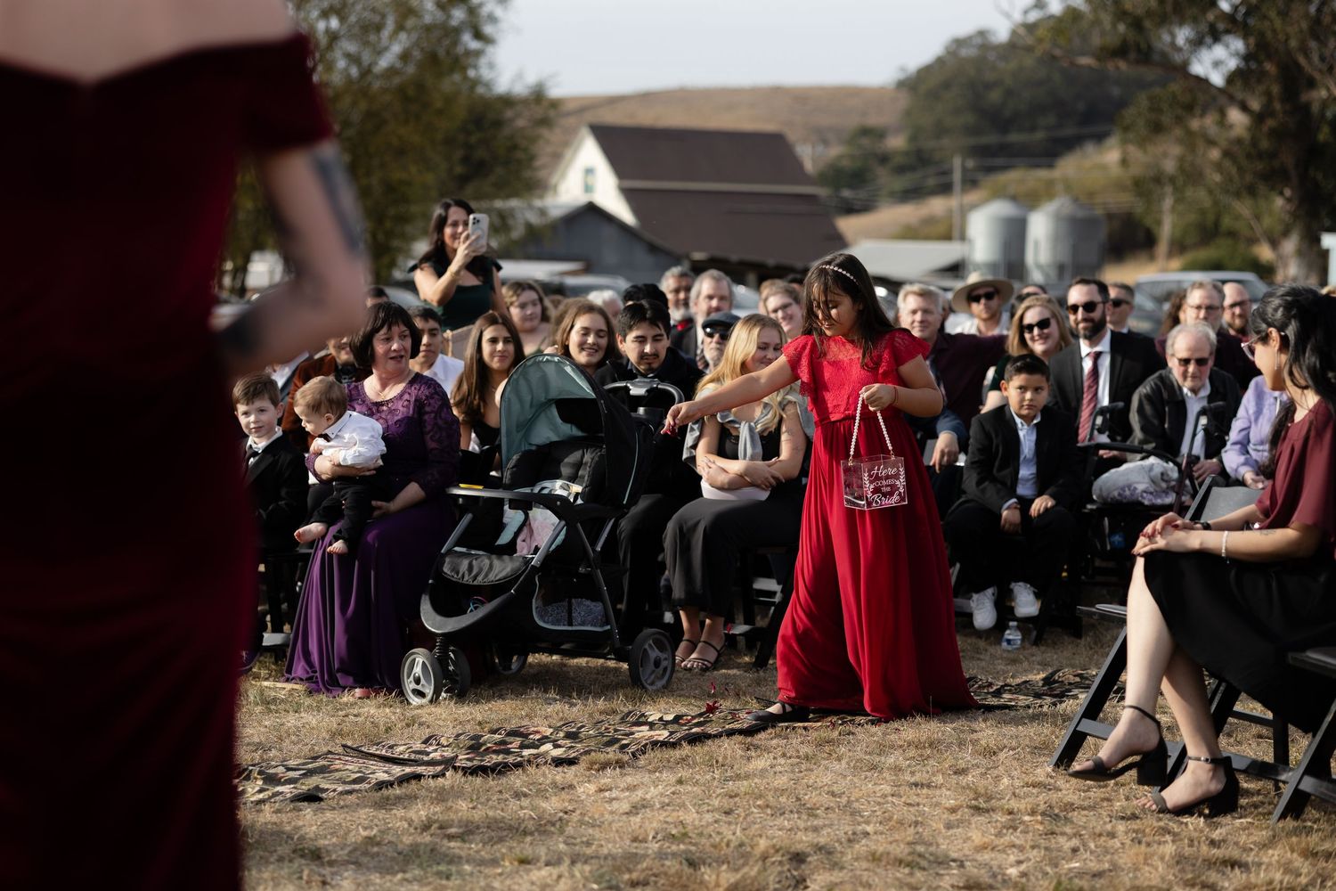 Guests seated at outdoor ceremony with scenic mountain backdrop.