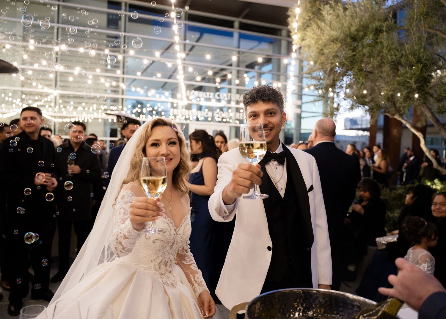 Newlyweds celebrate with a romantic dance under twinkling reception lights.