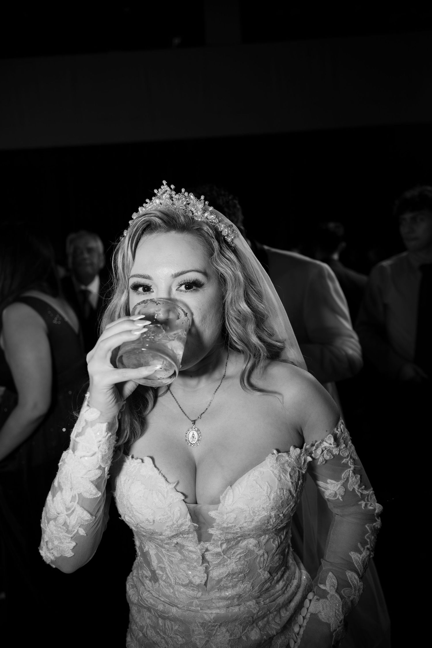 Black and white portrait of bride in lace wedding dress with tiara.