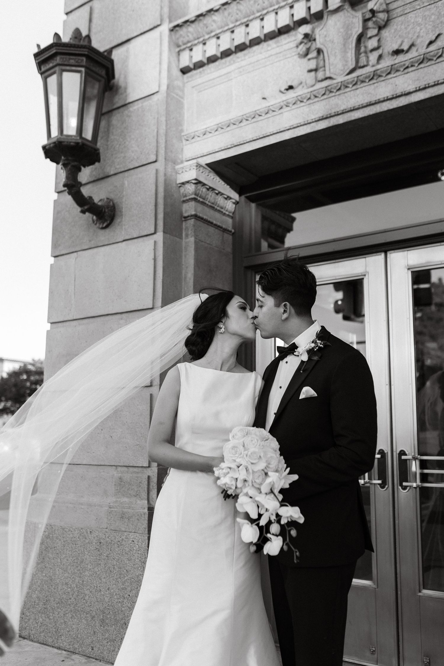 Black and white wedding portraits captured against classic architectural details.