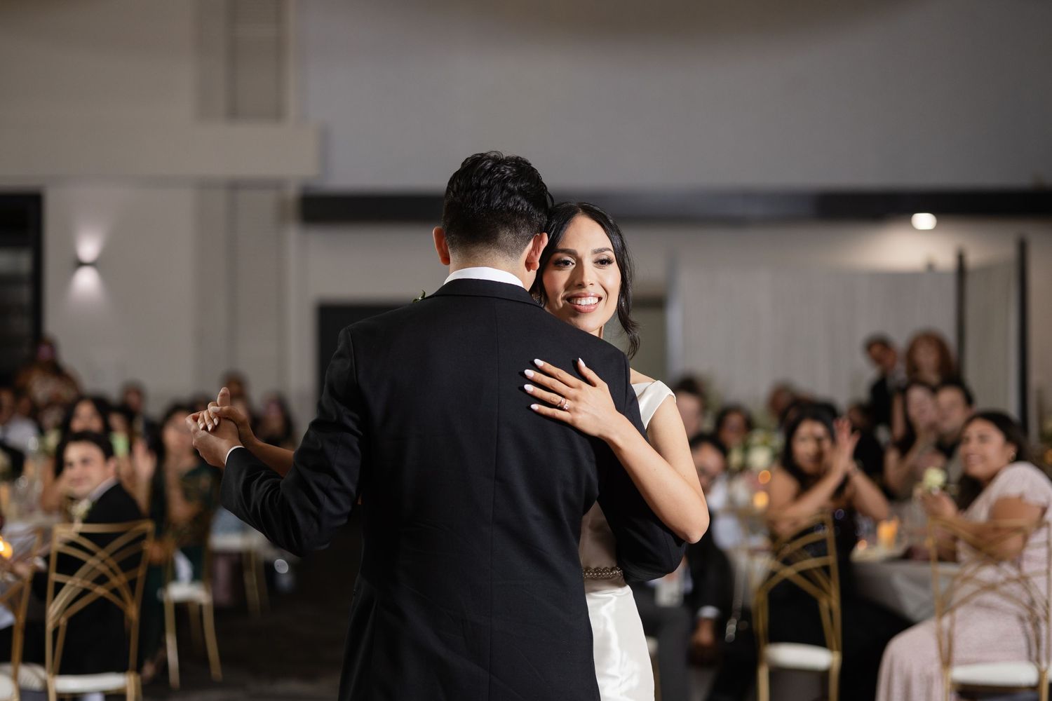 Wedding guests share laughter and dance moves during a lively reception.