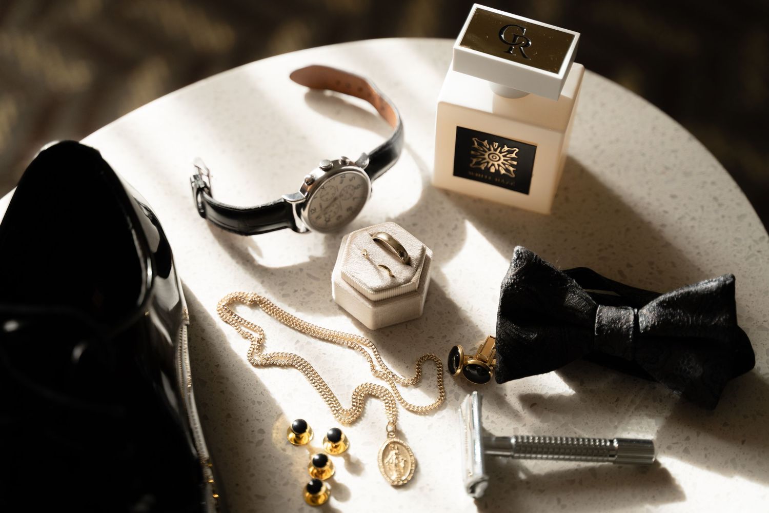 Close-up of elegant wedding accessories and jewelry in natural window light.