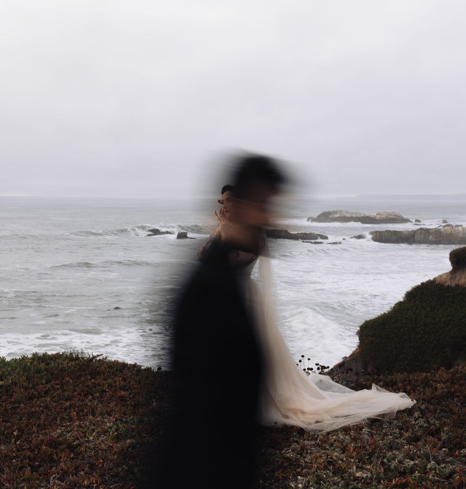 A motion-blurred silhouette creates a dreamy effect against the ocean backdrop.