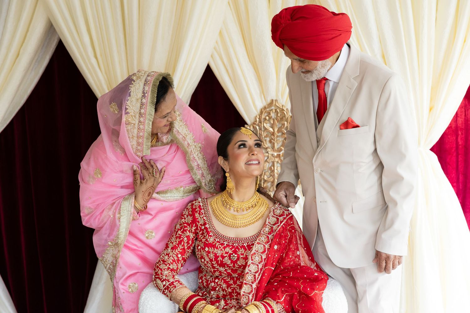 Traditional wedding ceremony scene with participants in formal cultural attire including red and white garments.