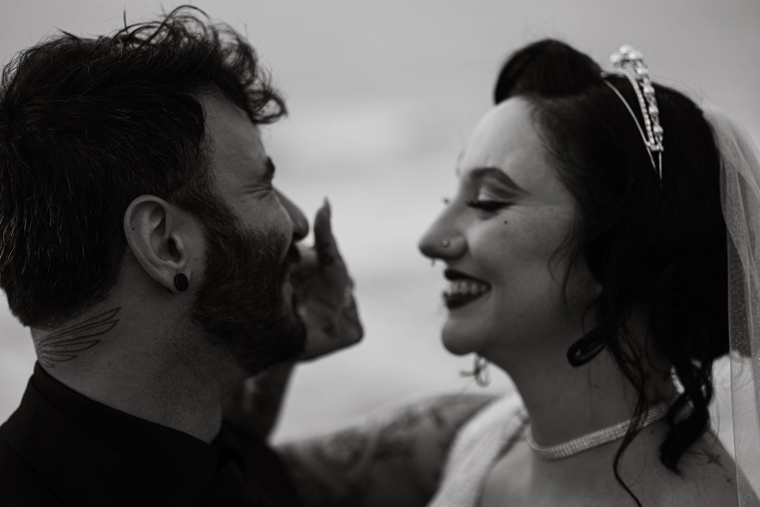 Black and white profile portraits showing emotional connection between couple.