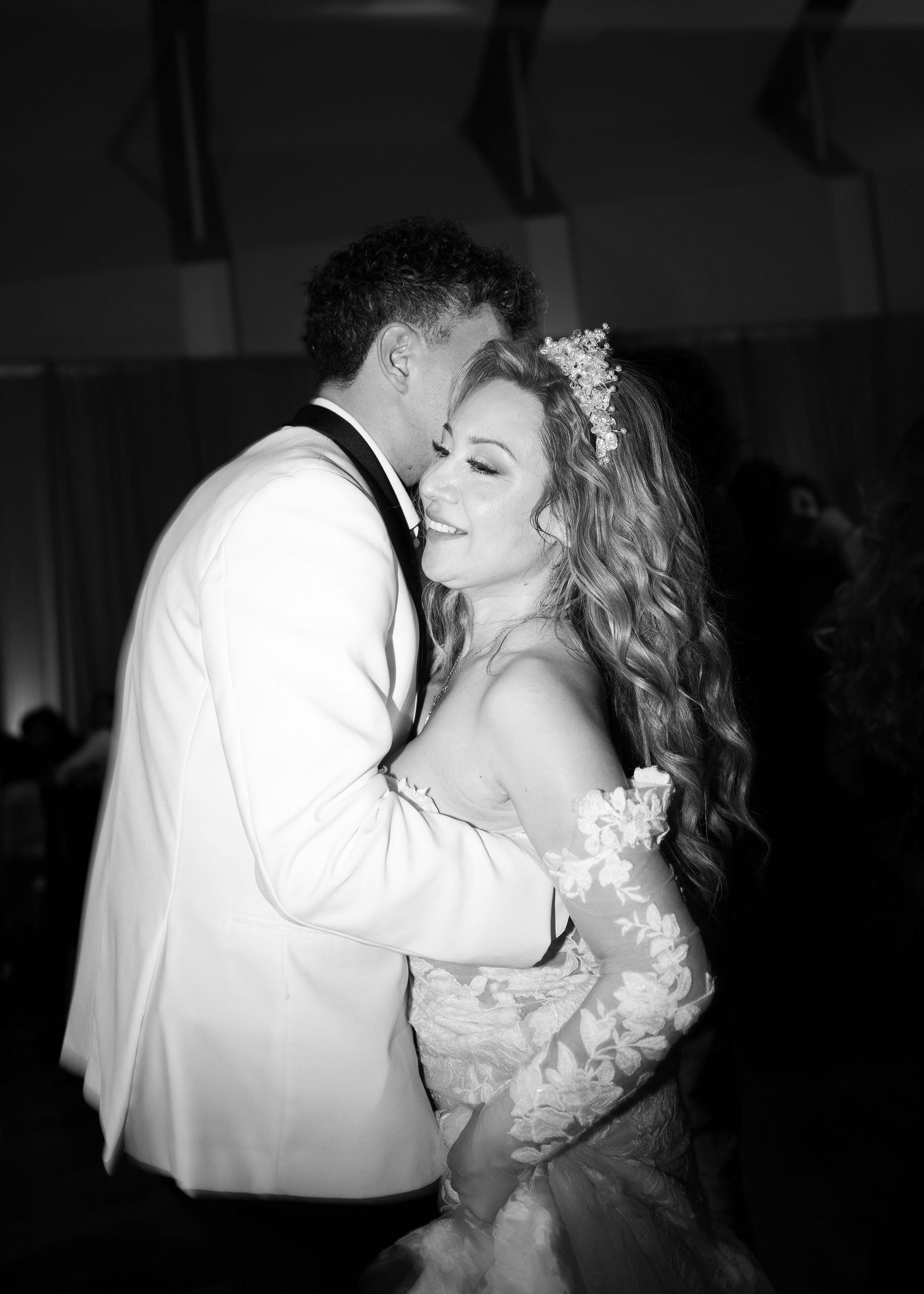 Black and white portrait of newlyweds sharing tender moment during first dance.