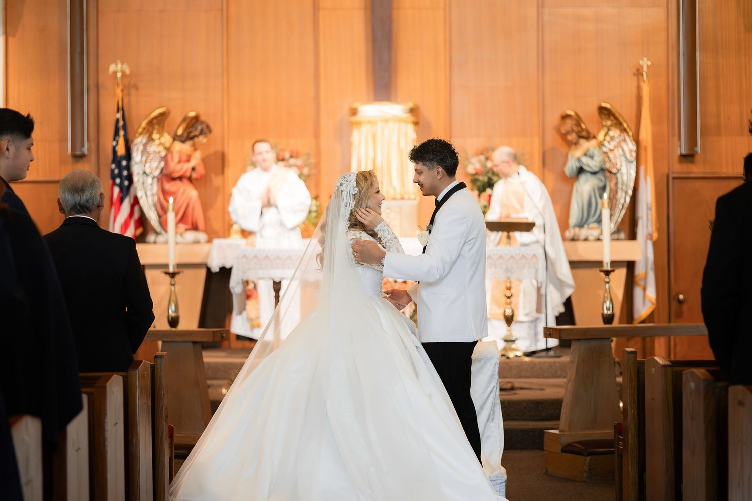 A couple exchanges vows during their wedding ceremony in a traditional church setting.