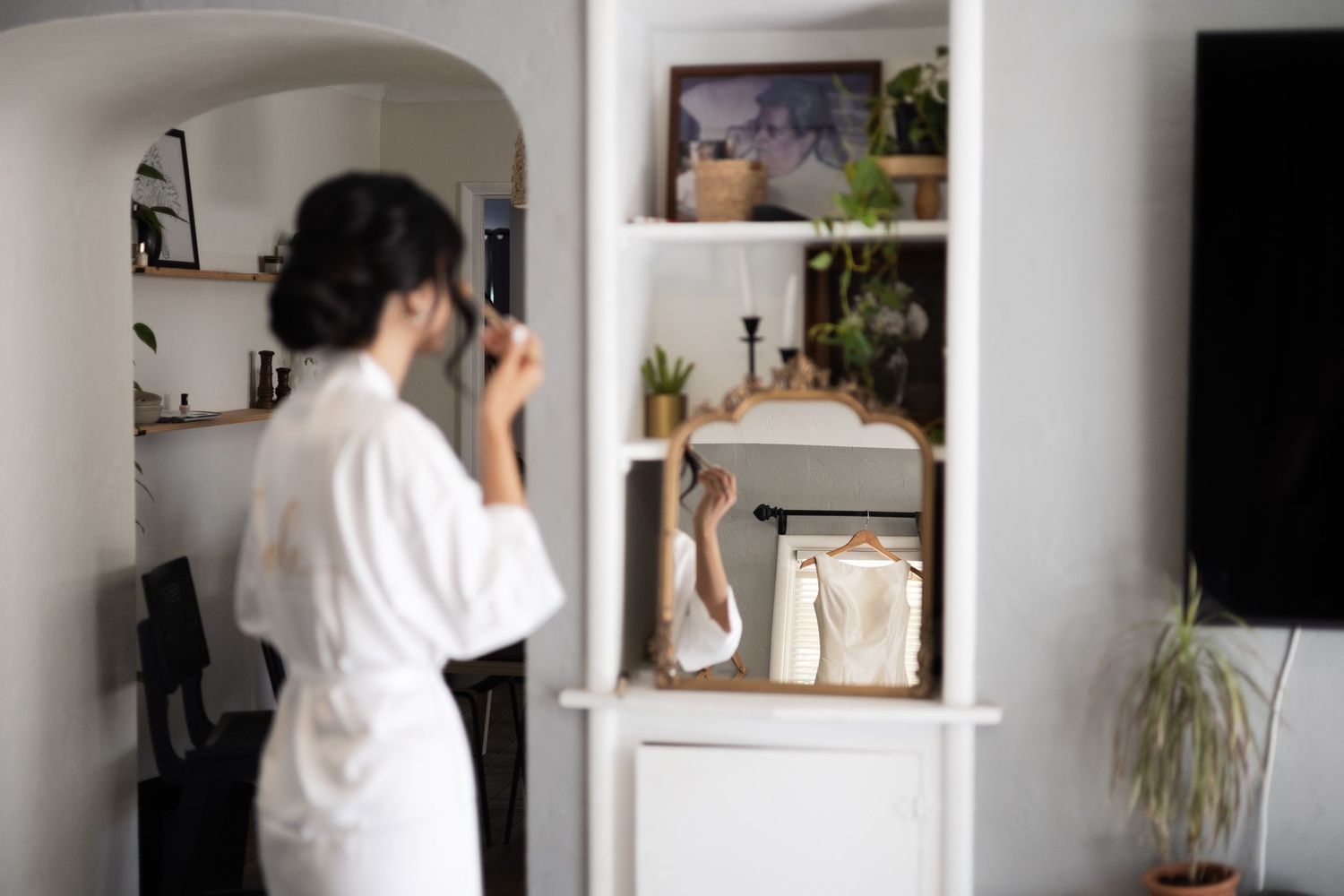 Minimalist white room interior with built-in shelves and natural lighting.