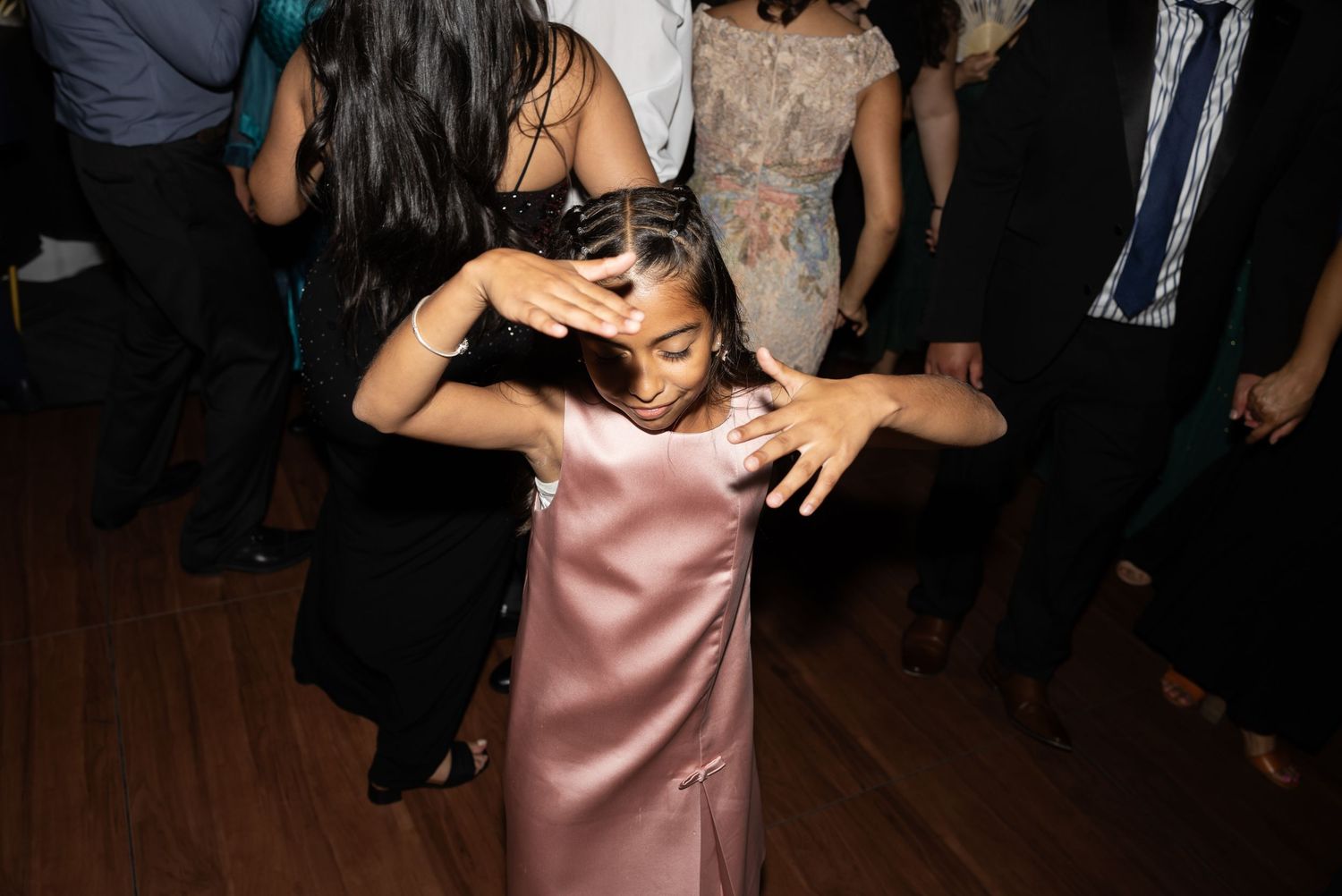 Party guests dancing and socializing at a formal evening celebration.