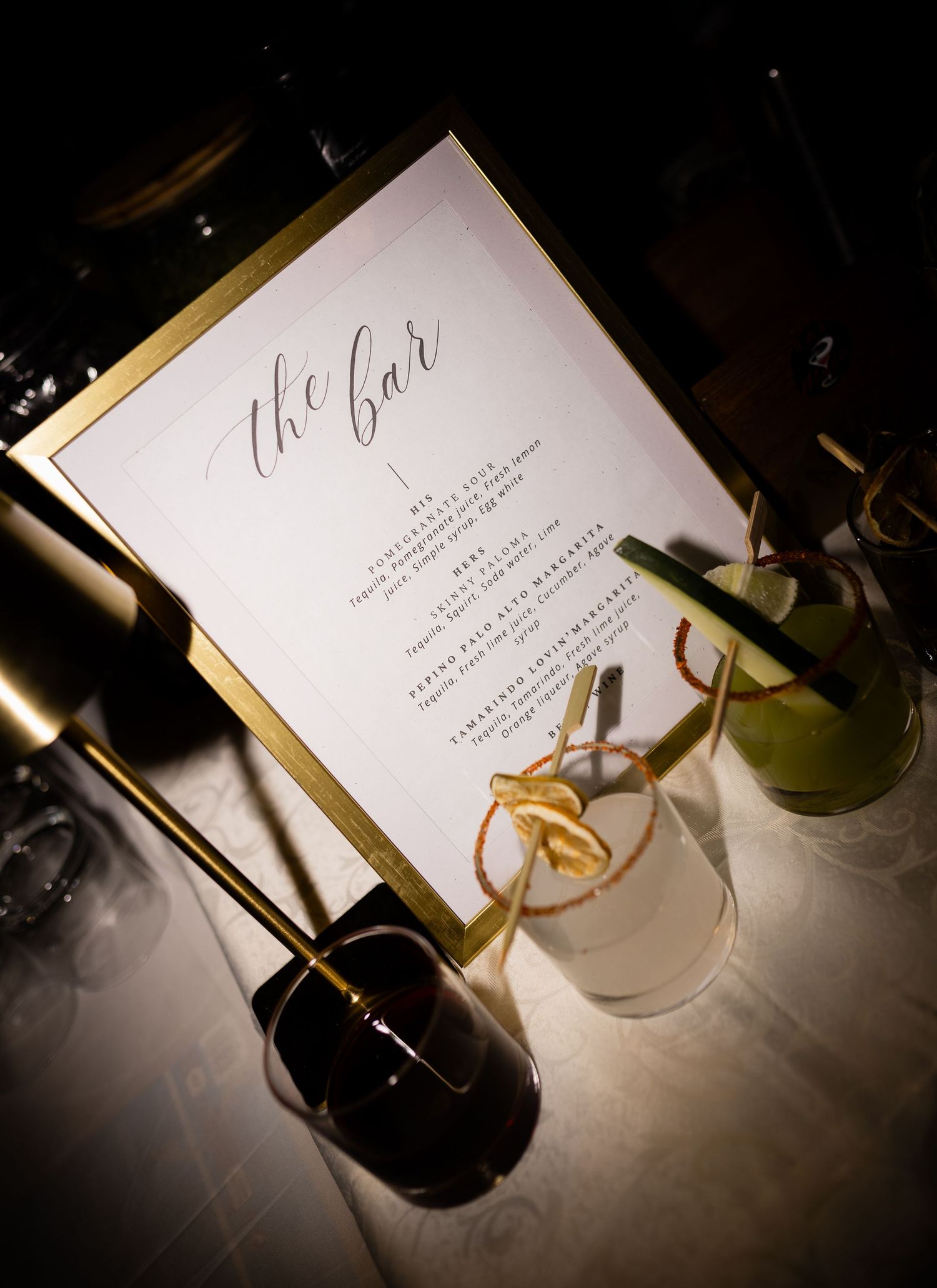Artistically lit wedding stationery and place settings create an elegant ambiance.