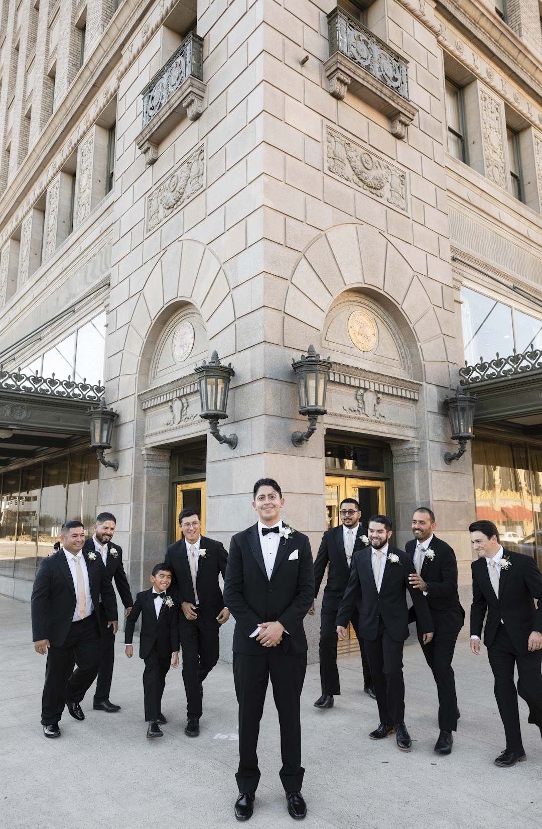 A gif of groomsmen bear hugging the groom.