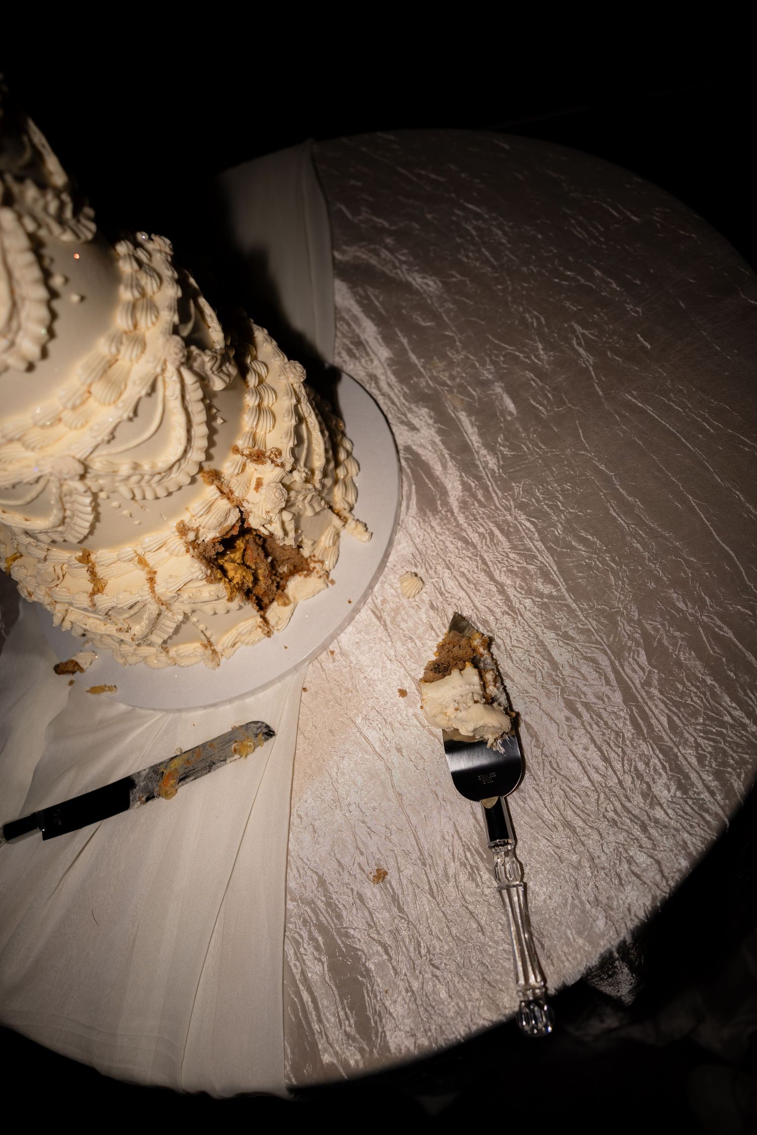 Wedding cake with intricate white frosting details photographed from different angles.
