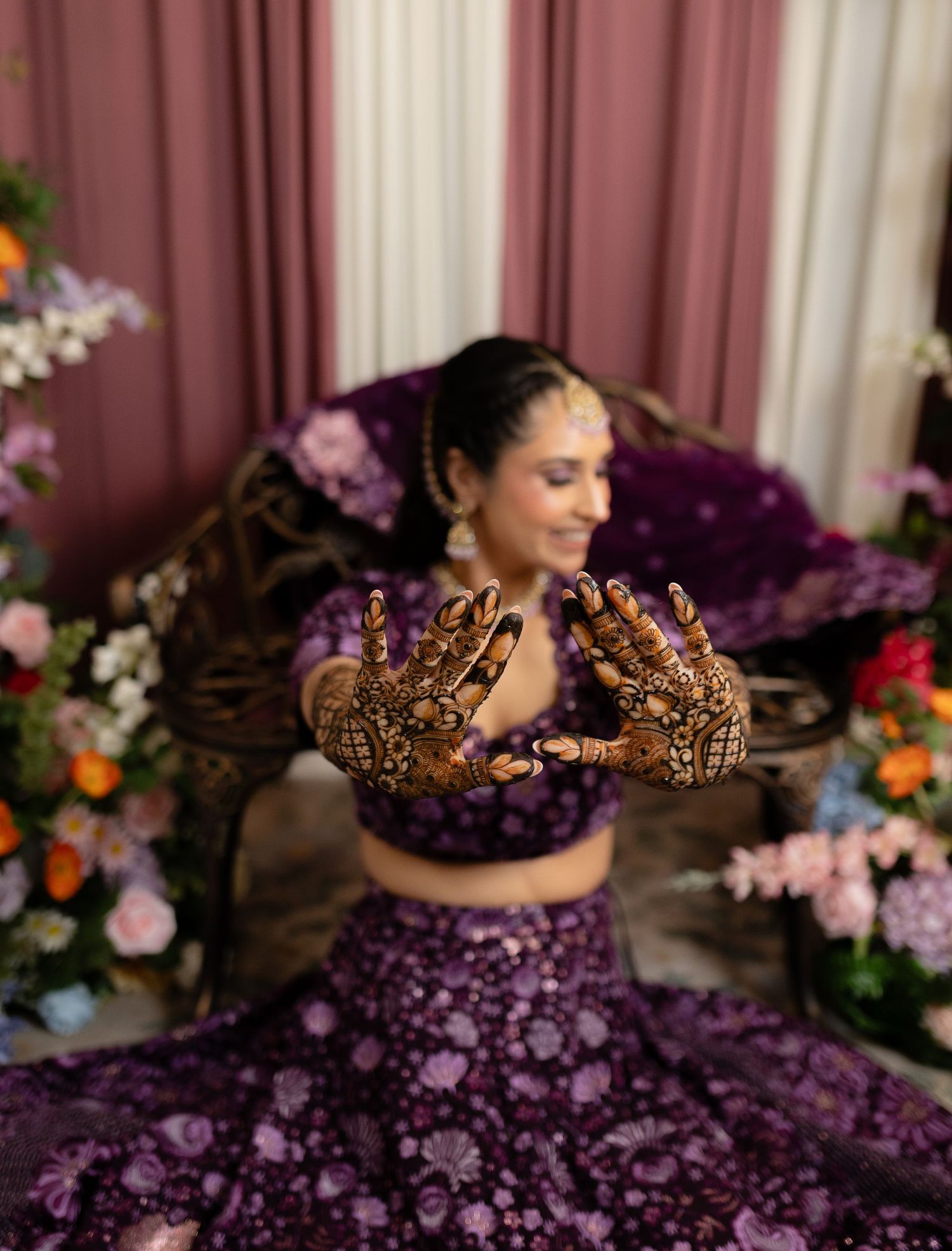 A purple floral dress creates a dreamy portrait scene with soft lighting and elegant styling.