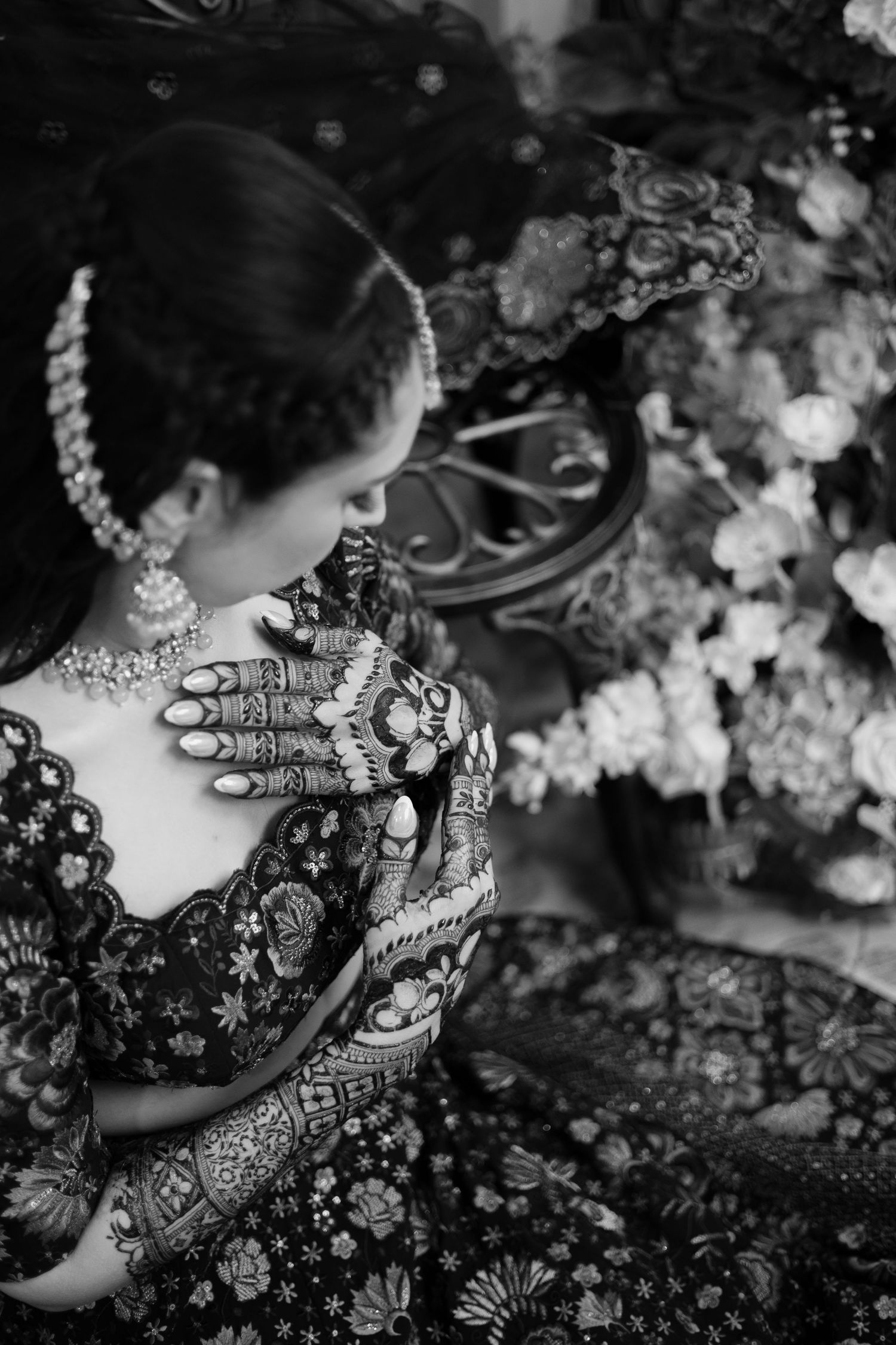 Black and white photos showing intricate henna designs and mehndi patterns on hands.