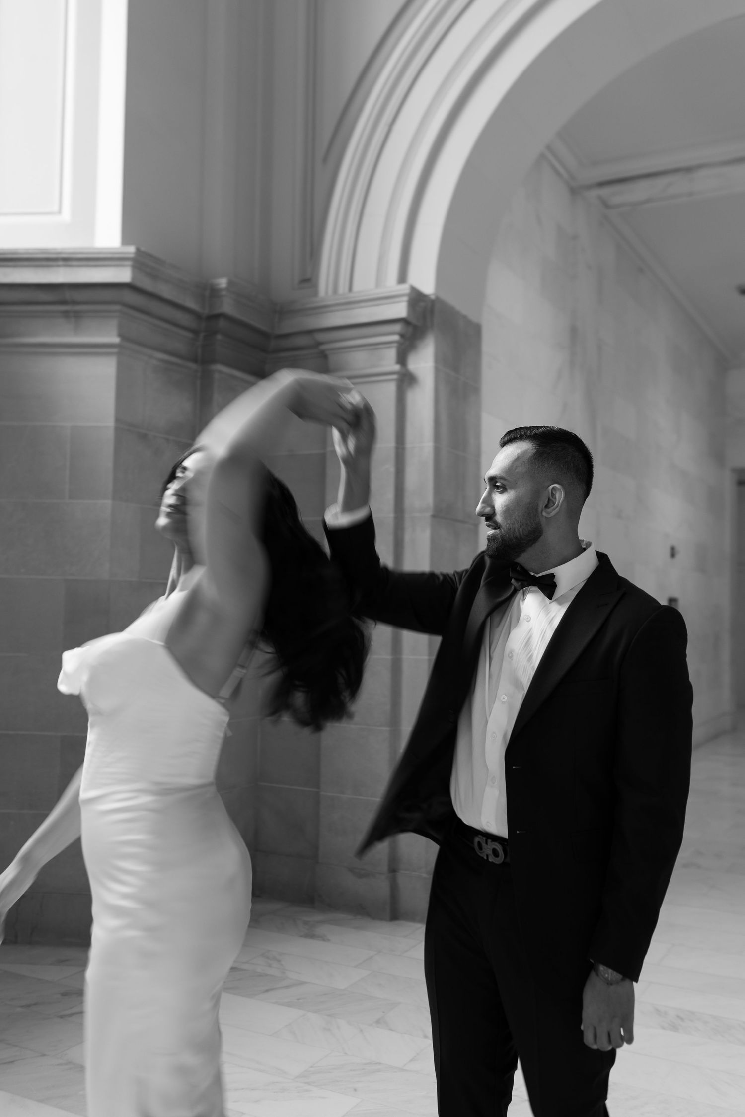 A black and white artistic sequence of a couple in formal attire dancing in an elegant architectural setting.