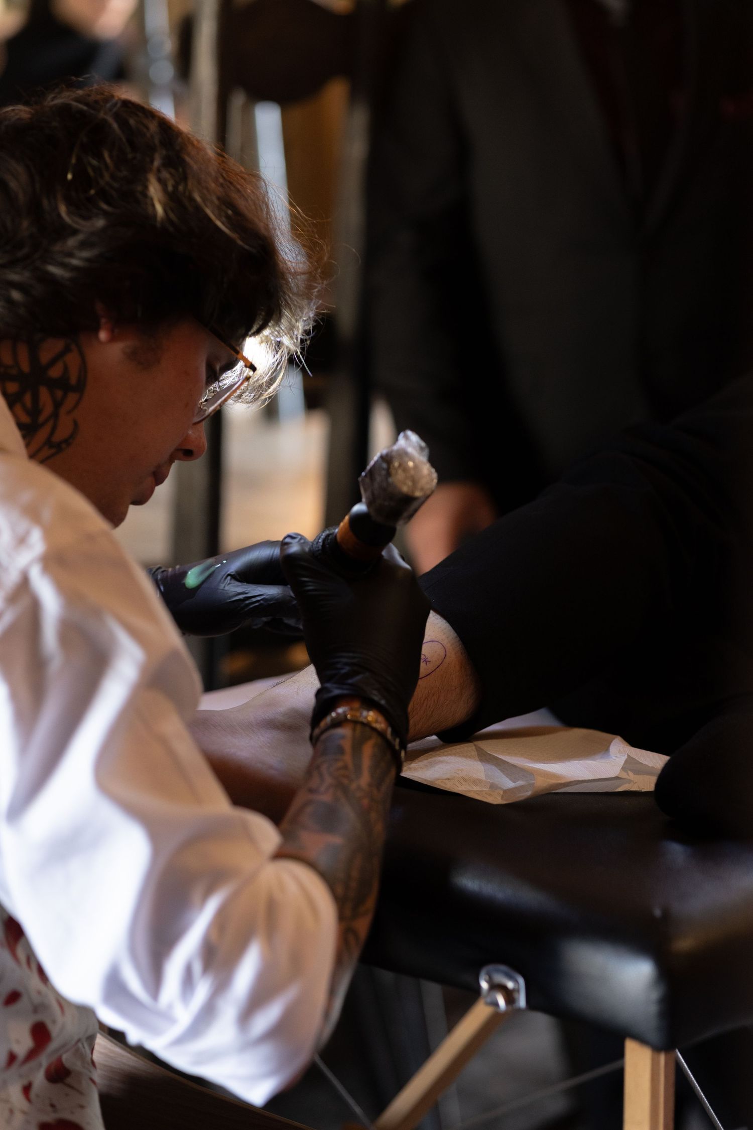 Close-up of someone in white clothing being prepared for an event.