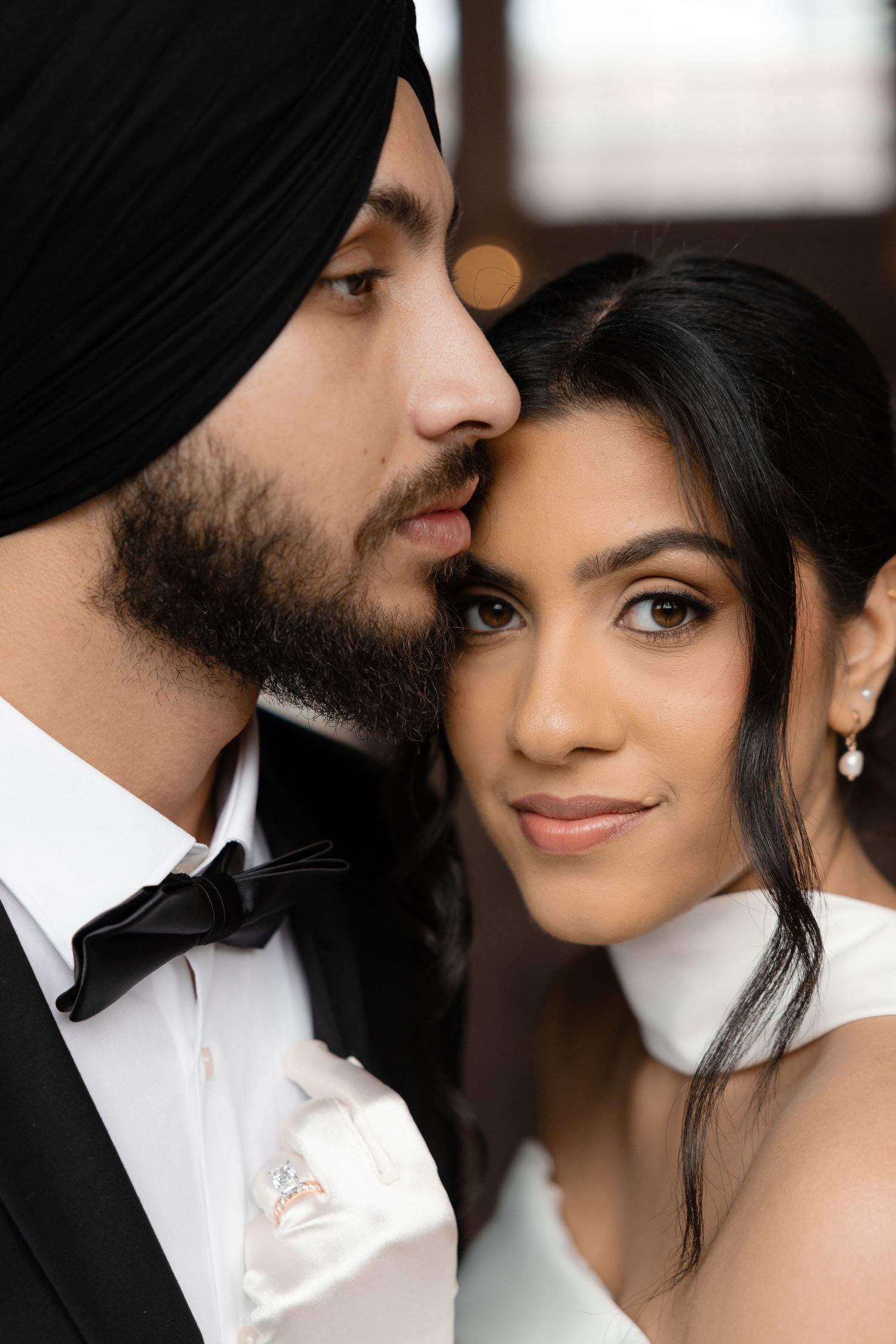 Close-up romantic portrait of a couple in wedding attire.