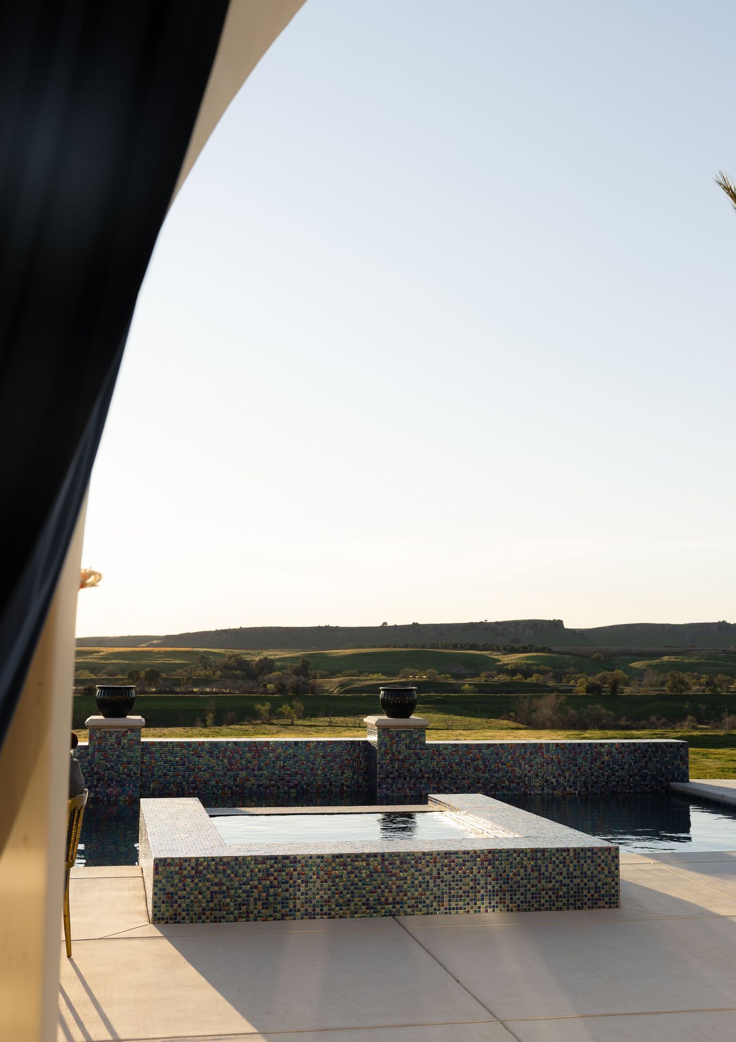 Panoramic view of stone benches against a sunset sky at an outdoor venue.