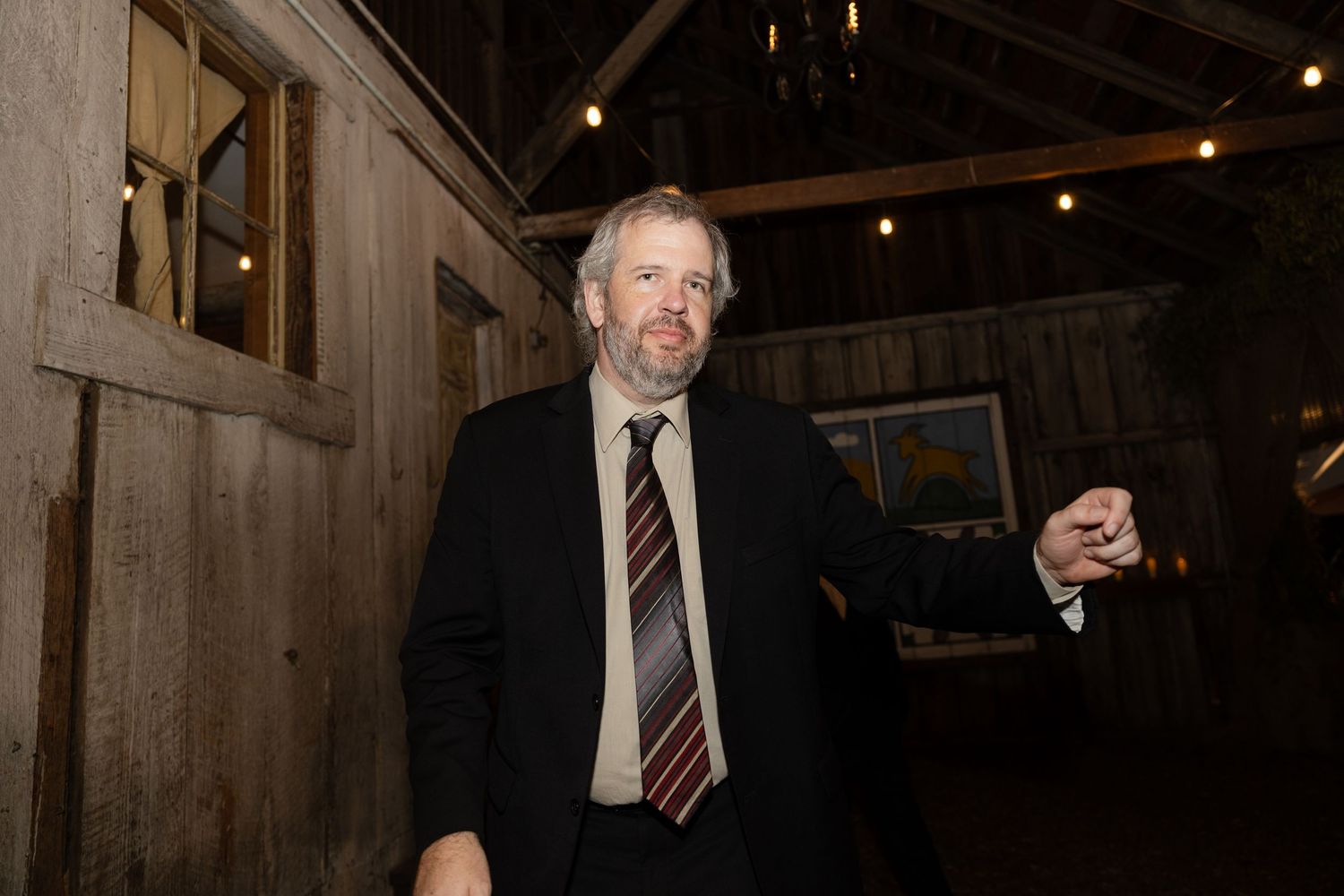 Evening celebration in a rustic barn venue with ambient lighting.