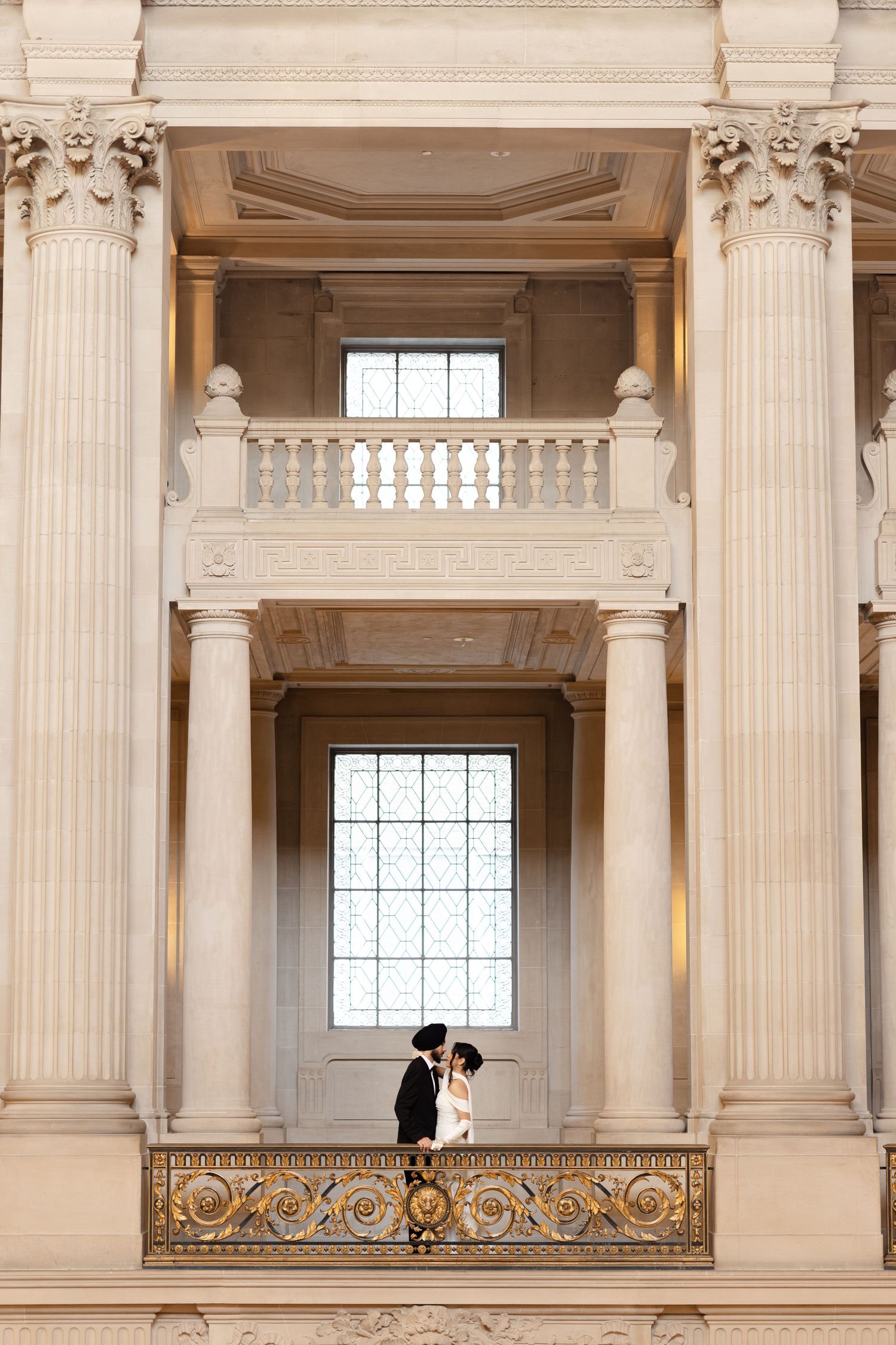 An elegant classical building interior with ornate columns and architectural details.