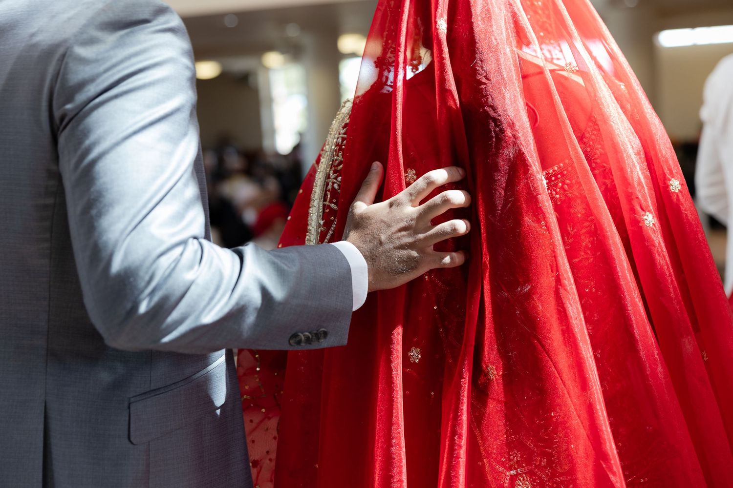 Close-up shots of traditional Sikh wedding ceremony moments featuring vibrant red ceremonial attire.