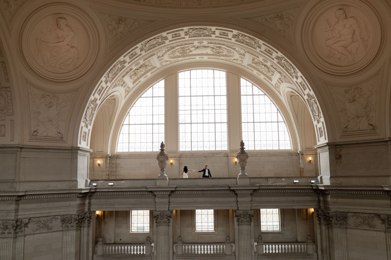 Ornate architectural panorama of a historic interior with arched windows, decorative moldings and classical details.