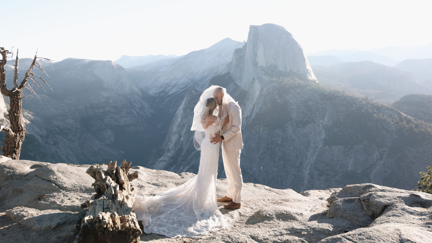 A dramatic wedding photo captured against the majestic backdrop of Yosemite's Half Dome.