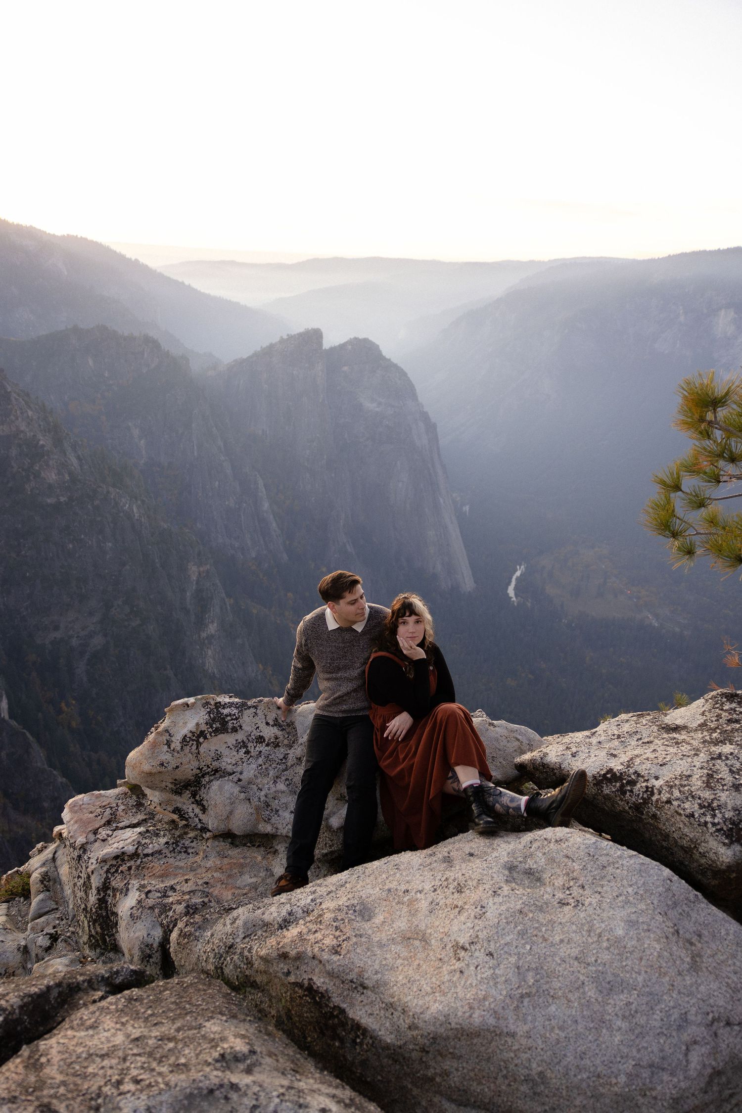 Romantic mountain top photo session with dramatic valley and waterfall views in background.