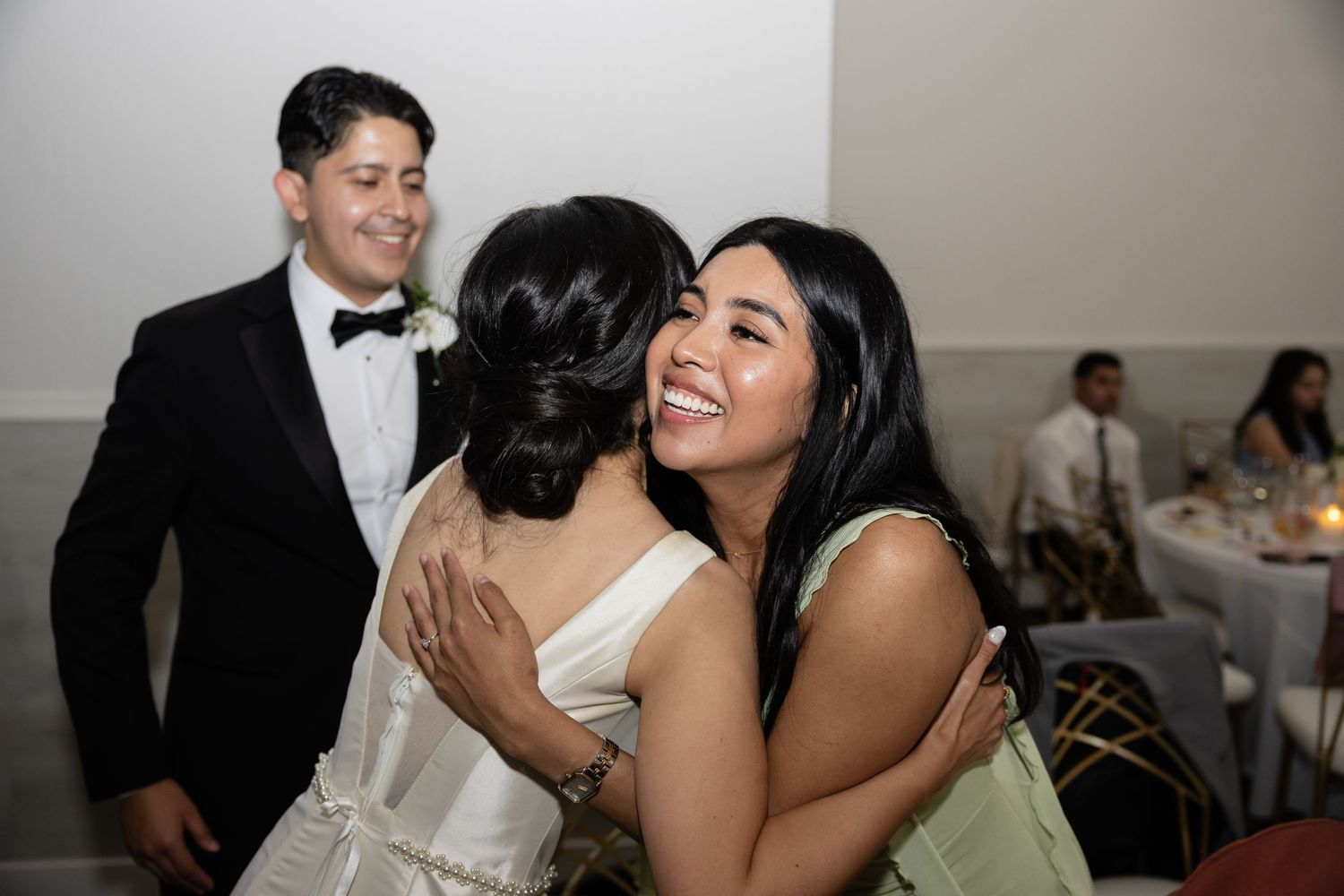 Wedding celebration candid moments captured during an indoor evening reception.