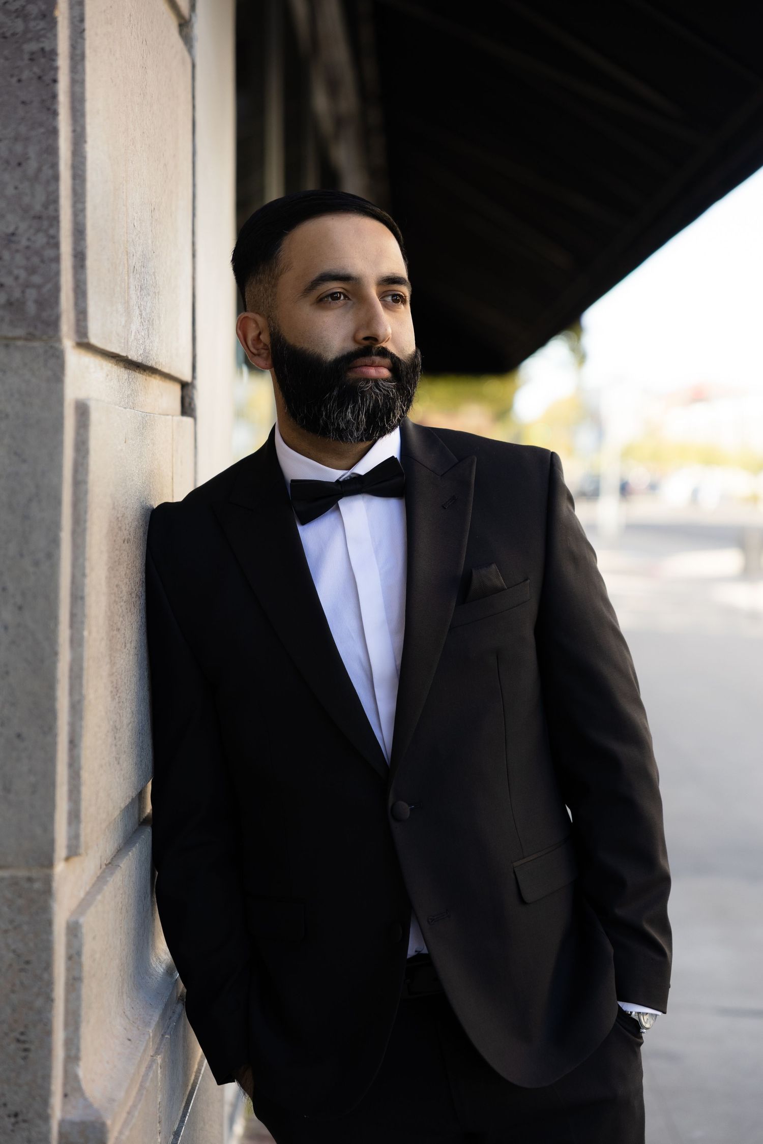 Classic black tuxedo detail shots against concrete wall background.