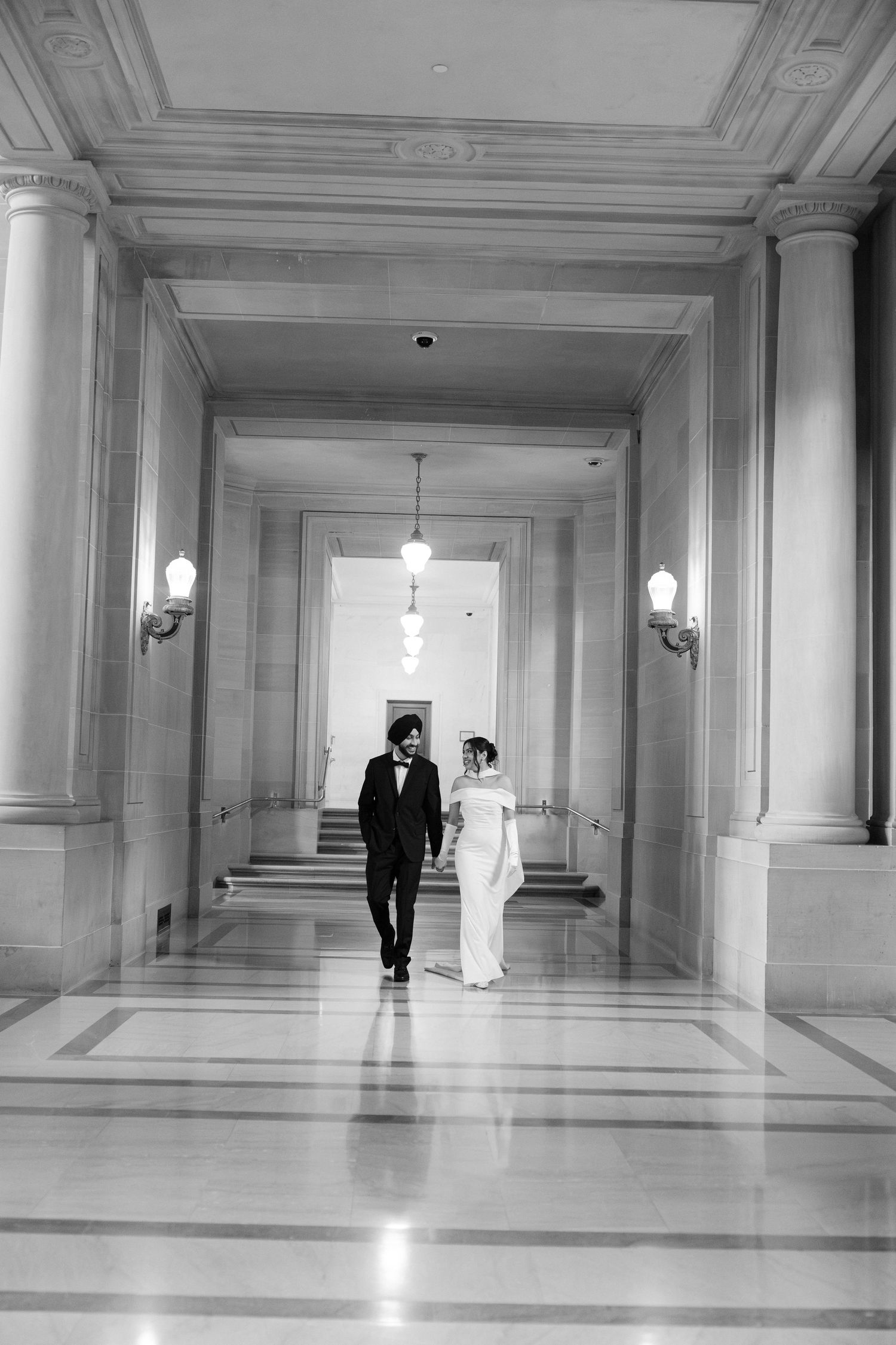 A sequence of artistic black and white photos in a grand marble hallway.