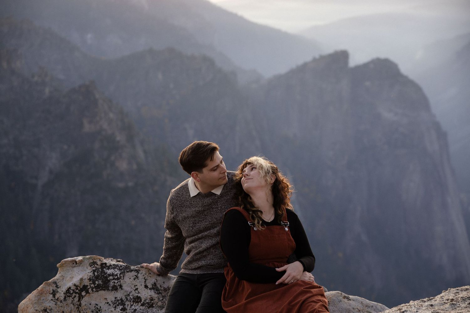 Intimate couple's portrait session on a mountain overlook during golden hour.