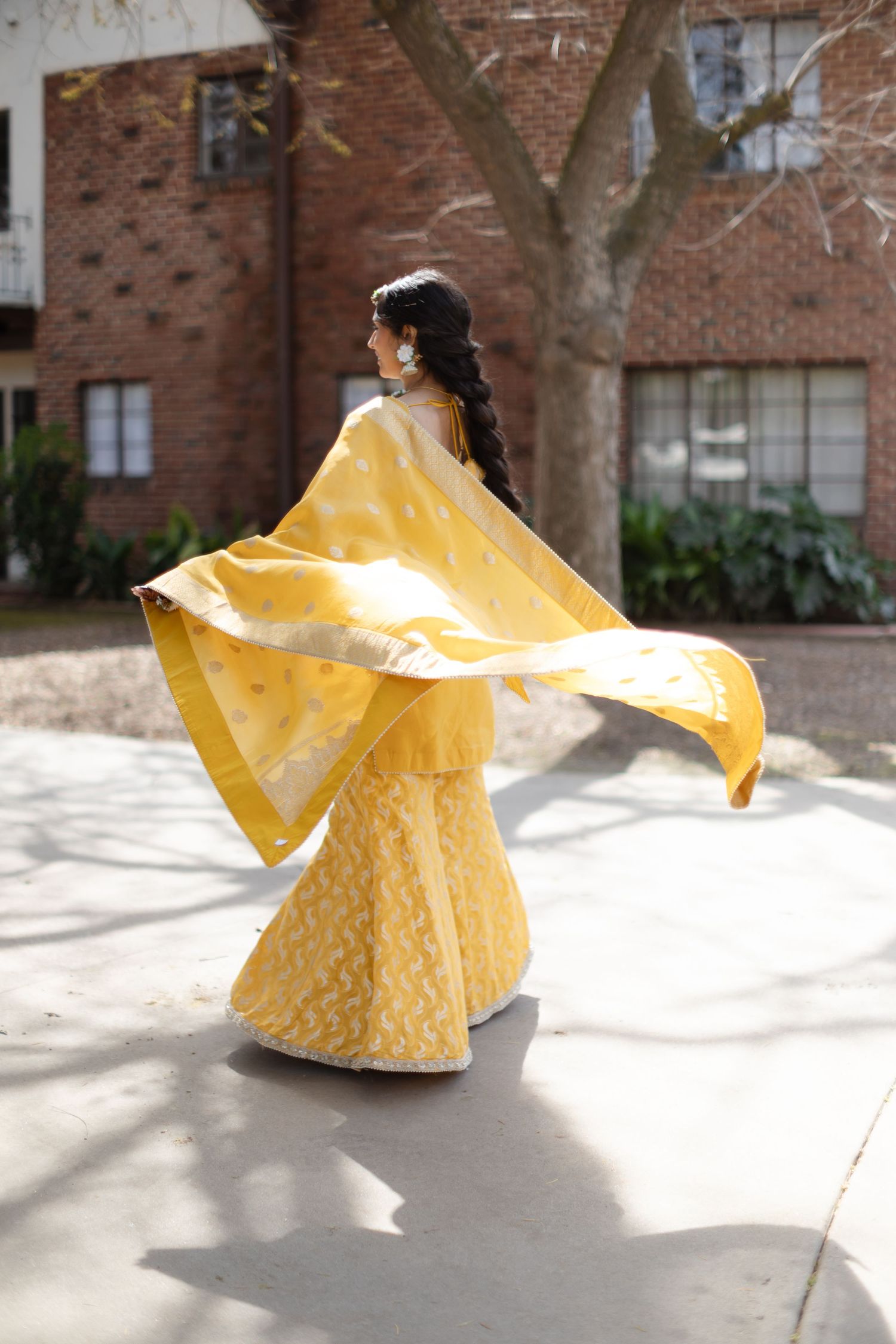 A yellow raincoat twirls in a sequence of motion shots against a brick building backdrop.