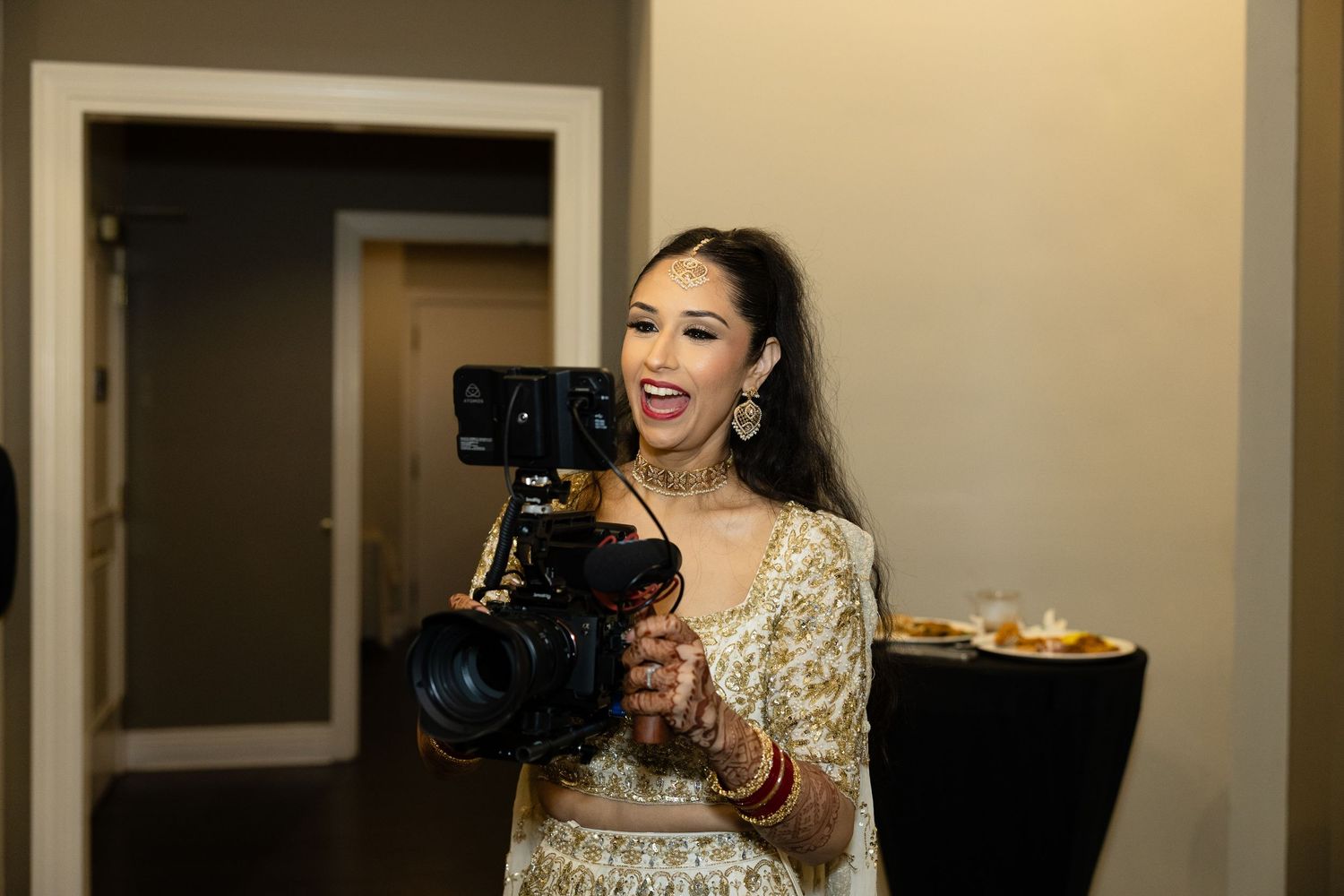 Guests enjoying a lively celebration in a modern banquet hall with warm lighting.