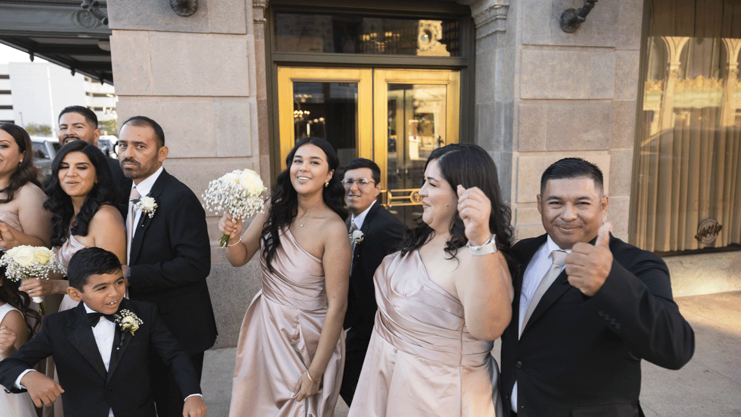 A gif of a bride and groom with their wedding party celebrating.