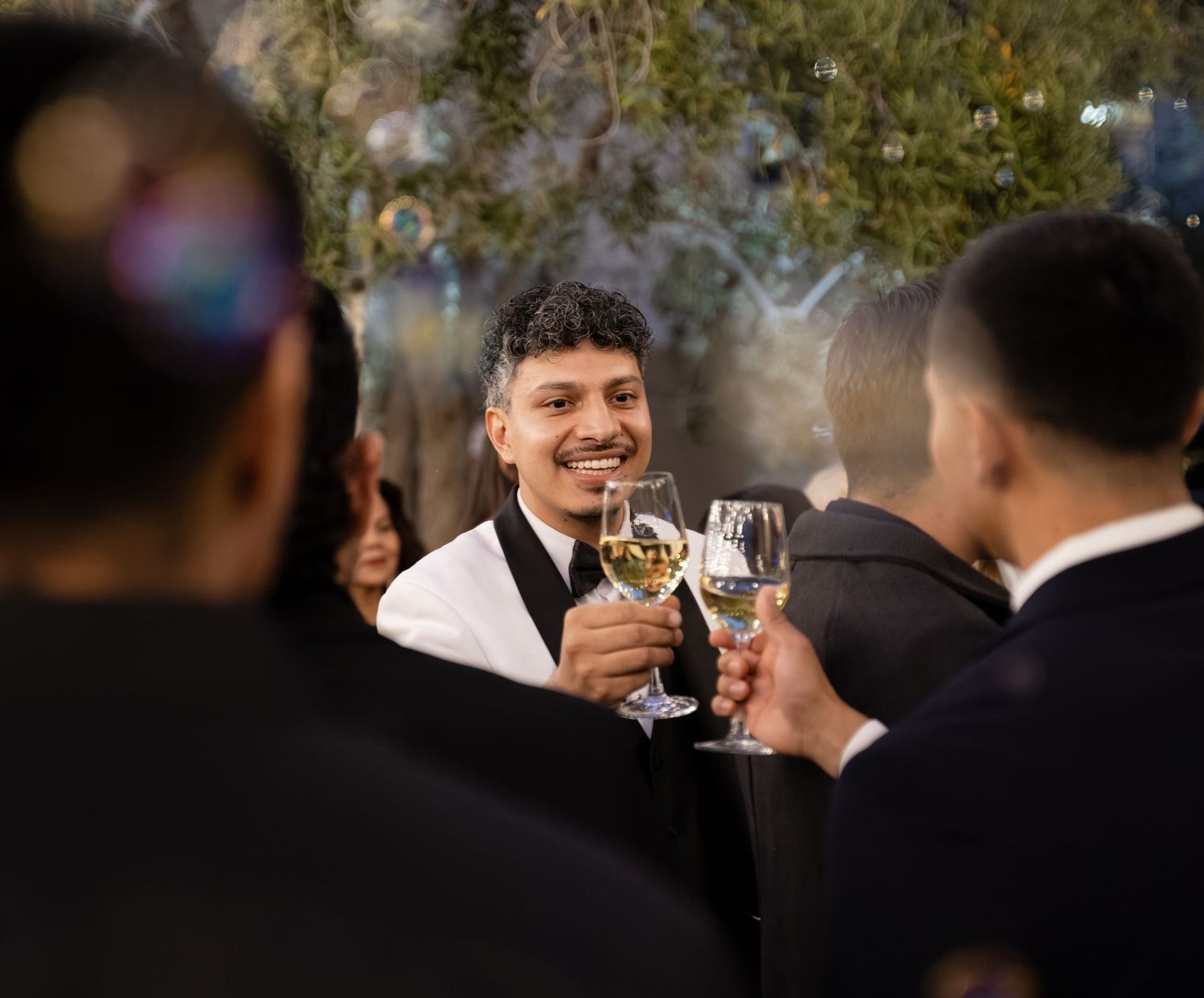 Wedding guests mingle and socialize at an elegant indoor reception venue.