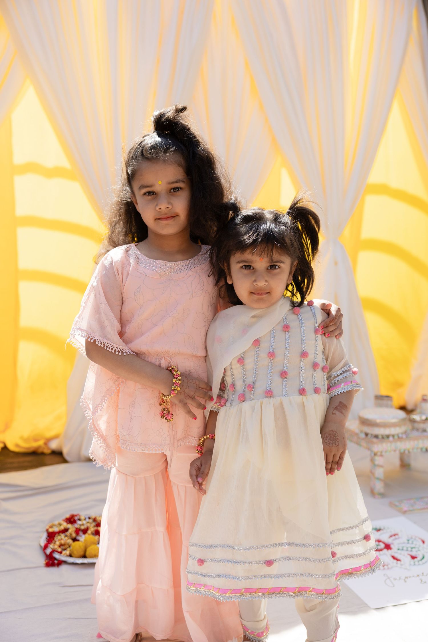 Festive party scene with yellow backdrop and white drapes decorated for celebration.