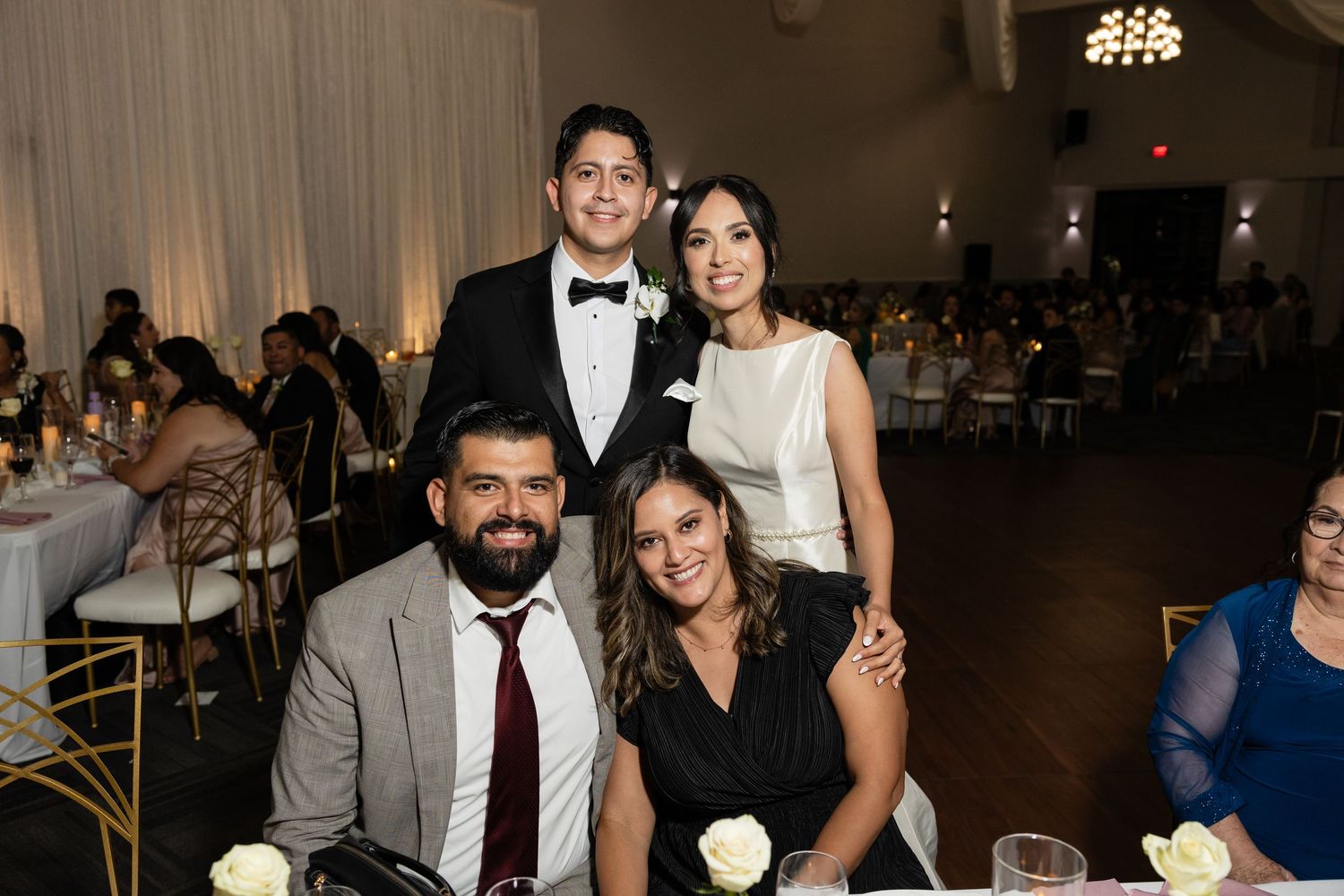 Wedding reception candid moments with guests celebrating and laughing together.