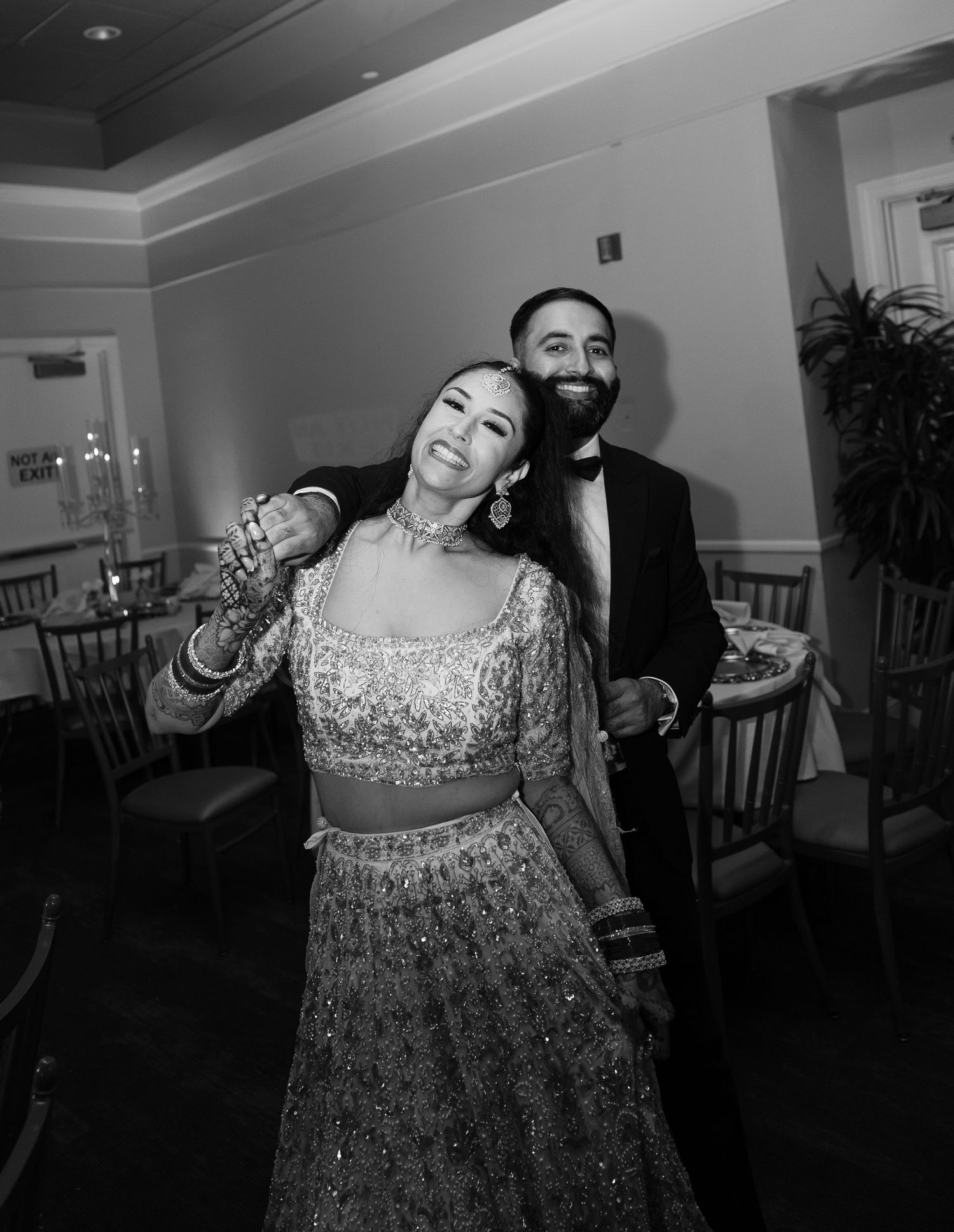 A sequence of black and white photos showing a person in a sparkly dress dancing joyfully at an event.
