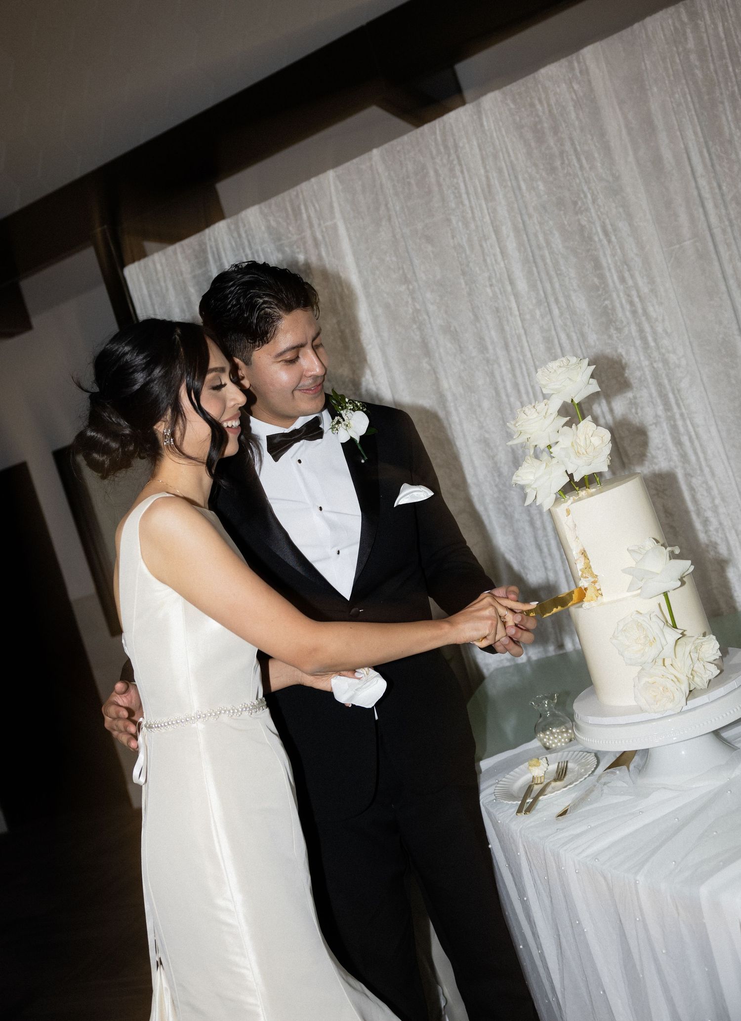 A couple enjoys their cake cutting moment at their wedding reception.