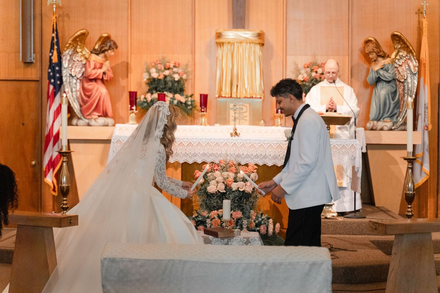 Church altar decorated with flowers and religious symbols during wedding ceremony.