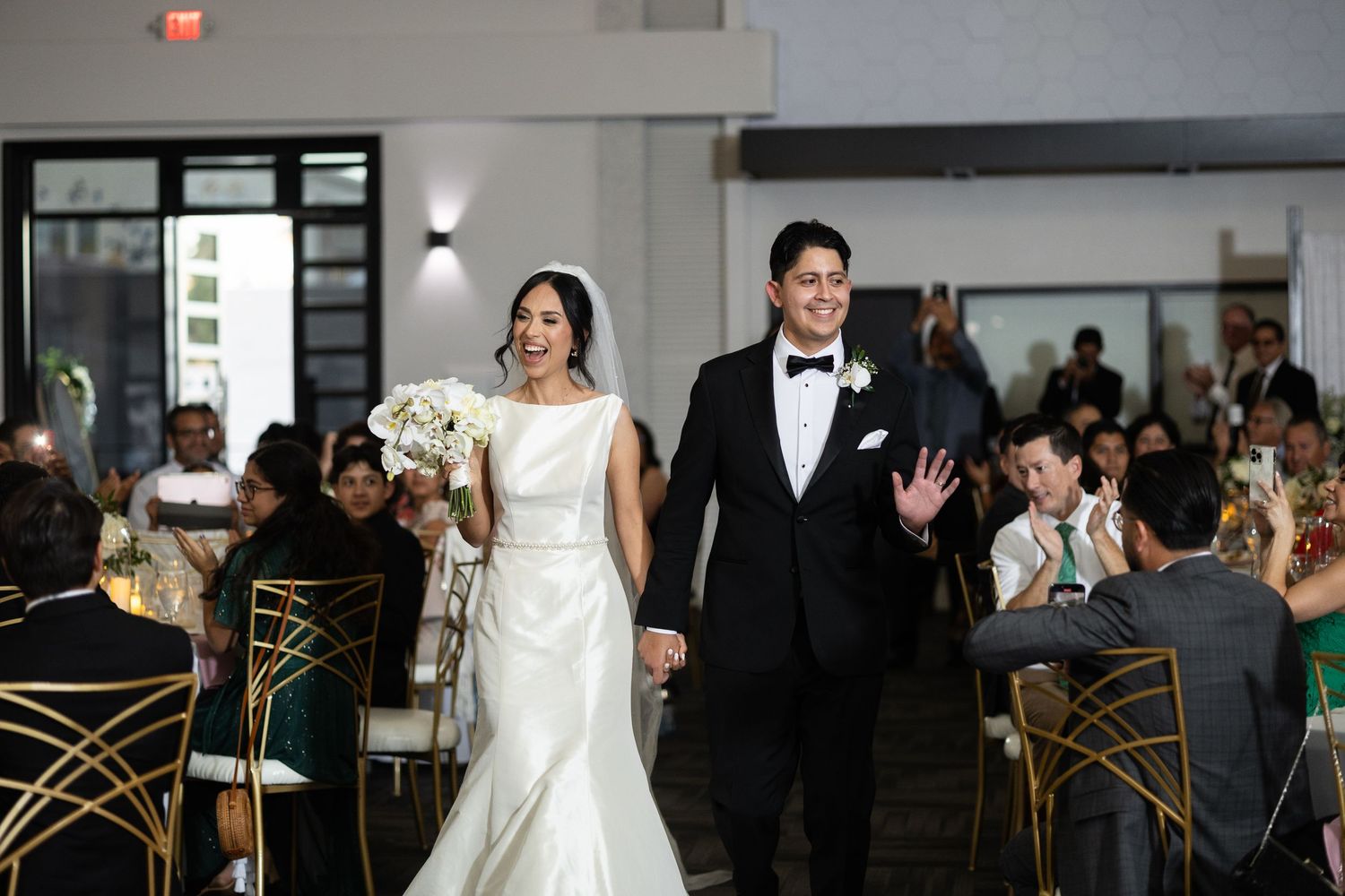 Modern wedding reception venue with geometric chairs and elegant white decor.