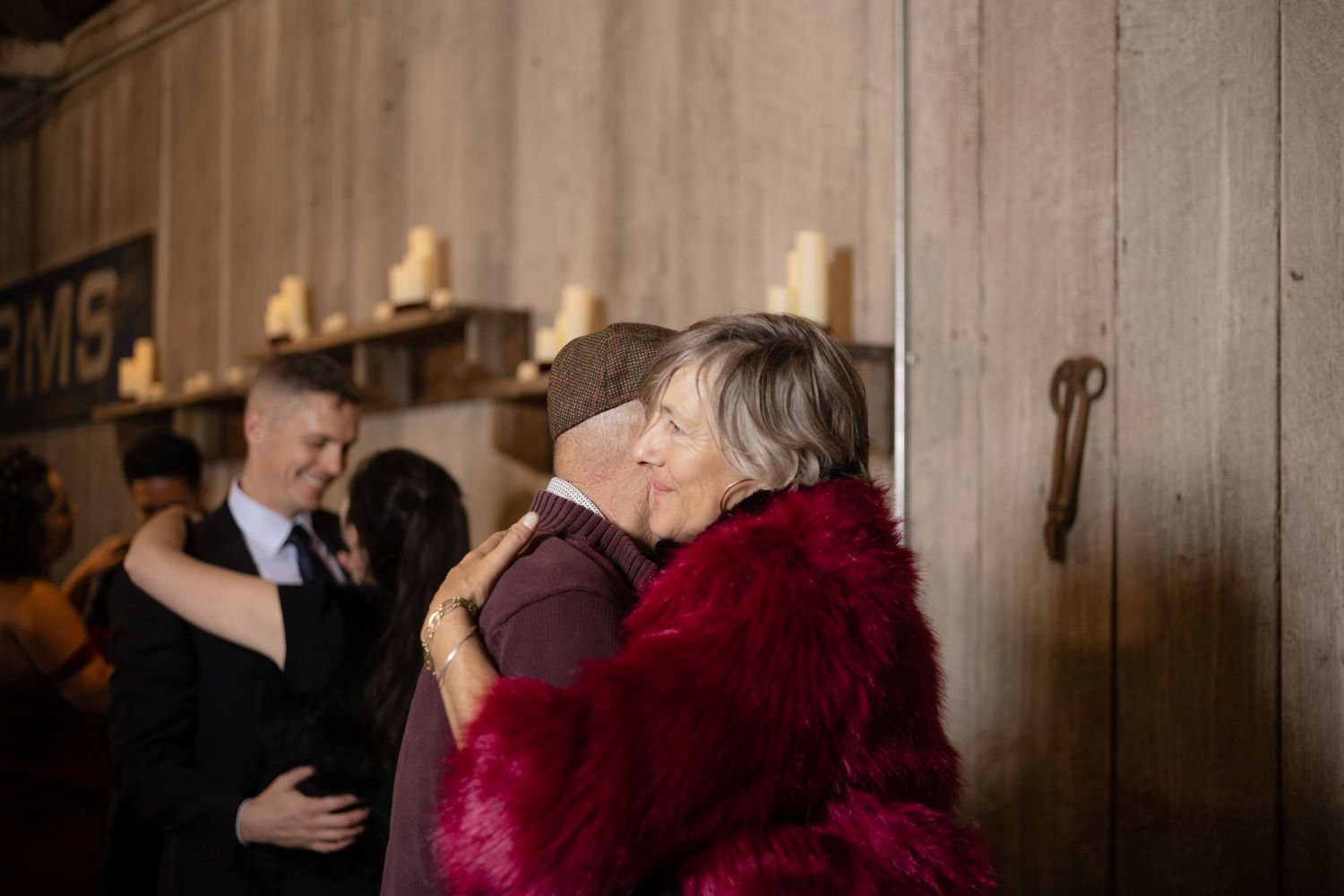 Couples dancing at an evening wedding reception in rustic barn venue.