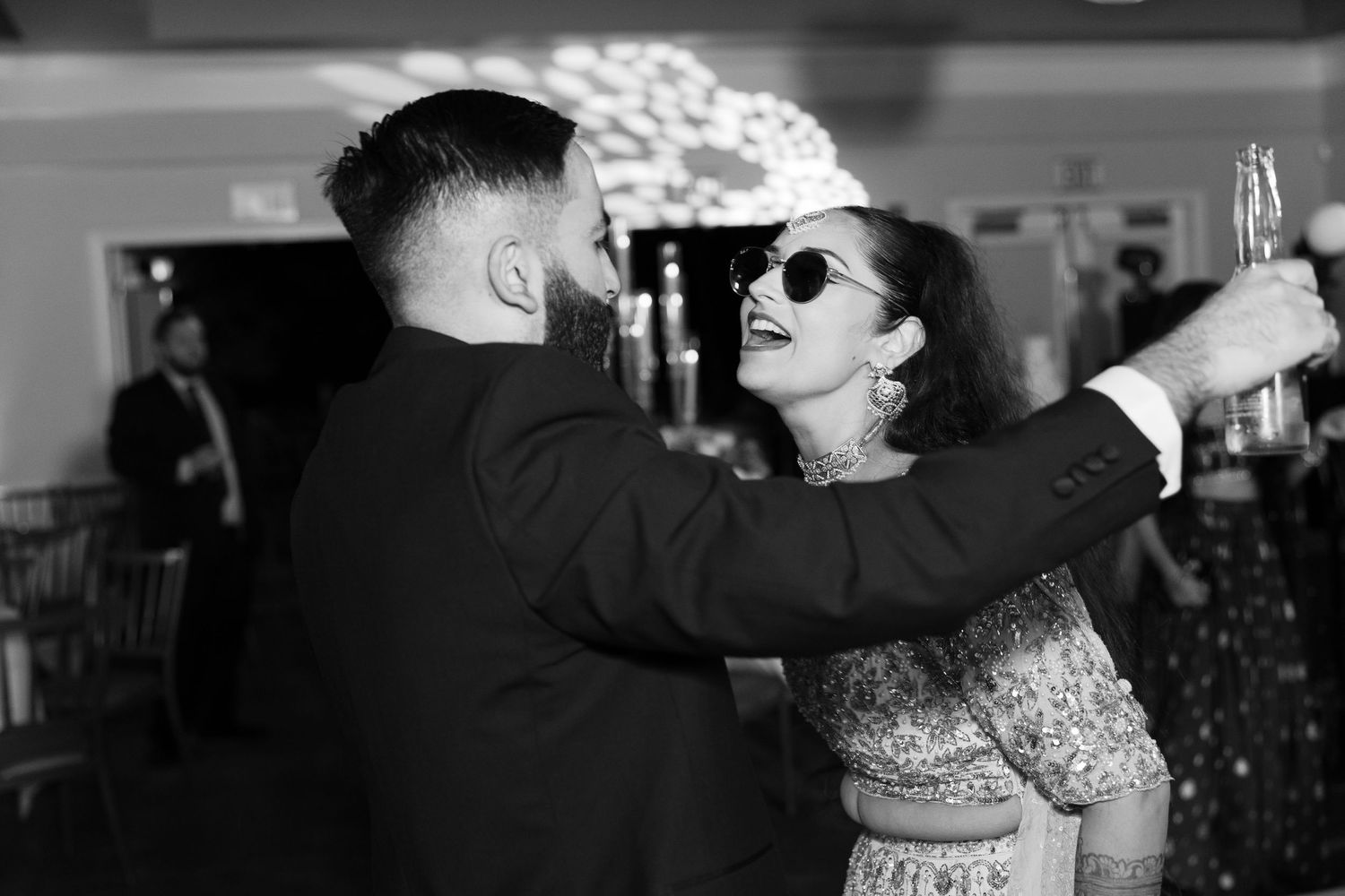 Black and white photos of guests mingling and drinking at a formal celebration.