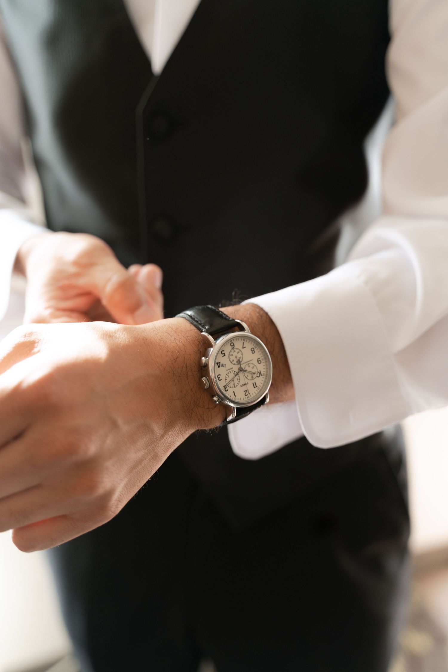 Detailed shots of hands adjusting a classic wristwatch.