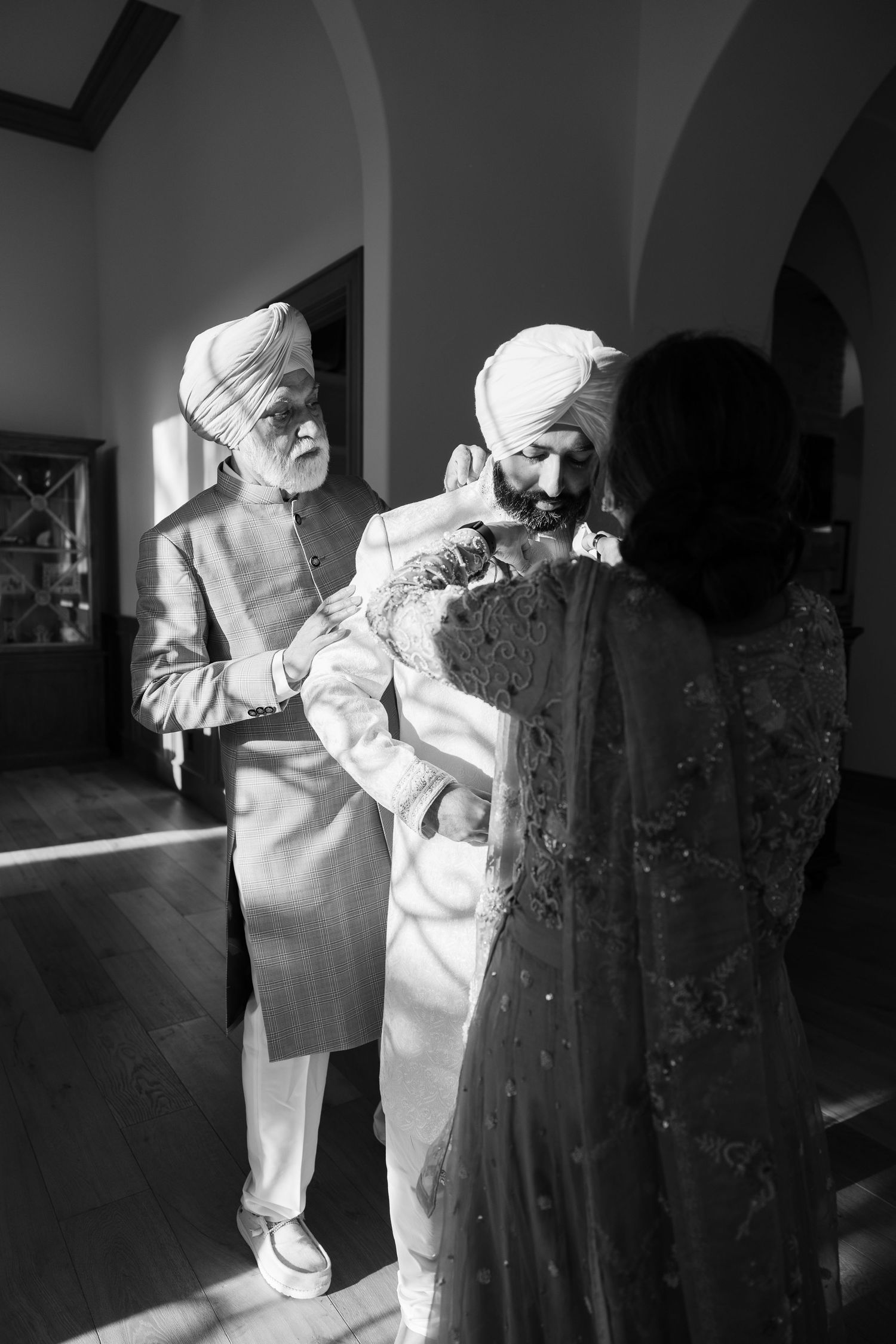 Artistic black and white photo series showing figures in white outfits interacting with vintage clothing.