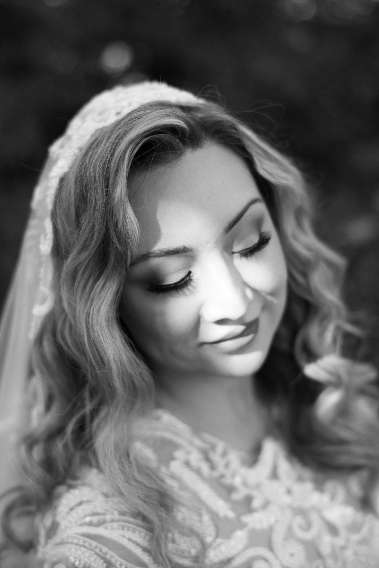 Ethereal black and white portrait showing soft bridal makeup and flowing hair.