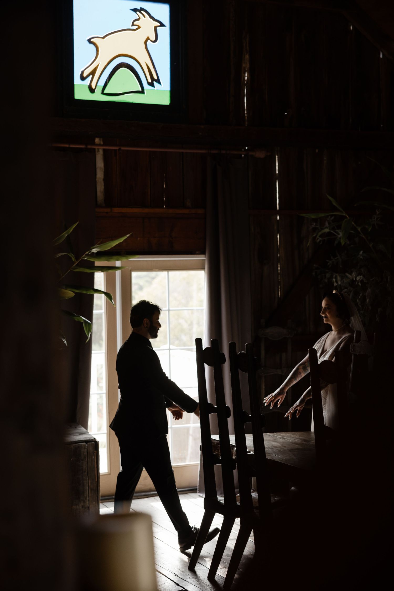 Artistic silhouette composition in barn with window light and decorative elements.